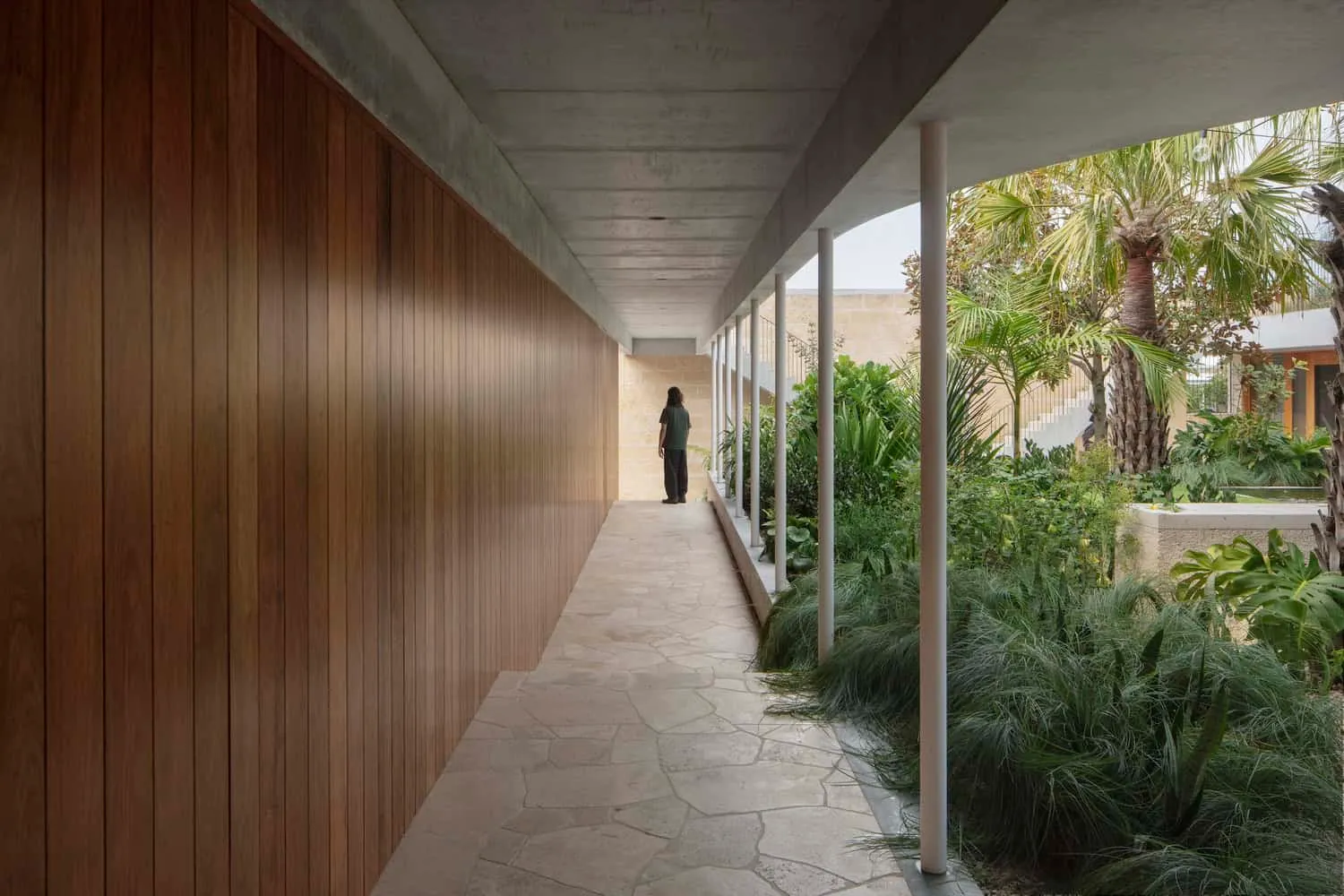 Stone walkway with wooden cladding and garden view inside the Newcastle home