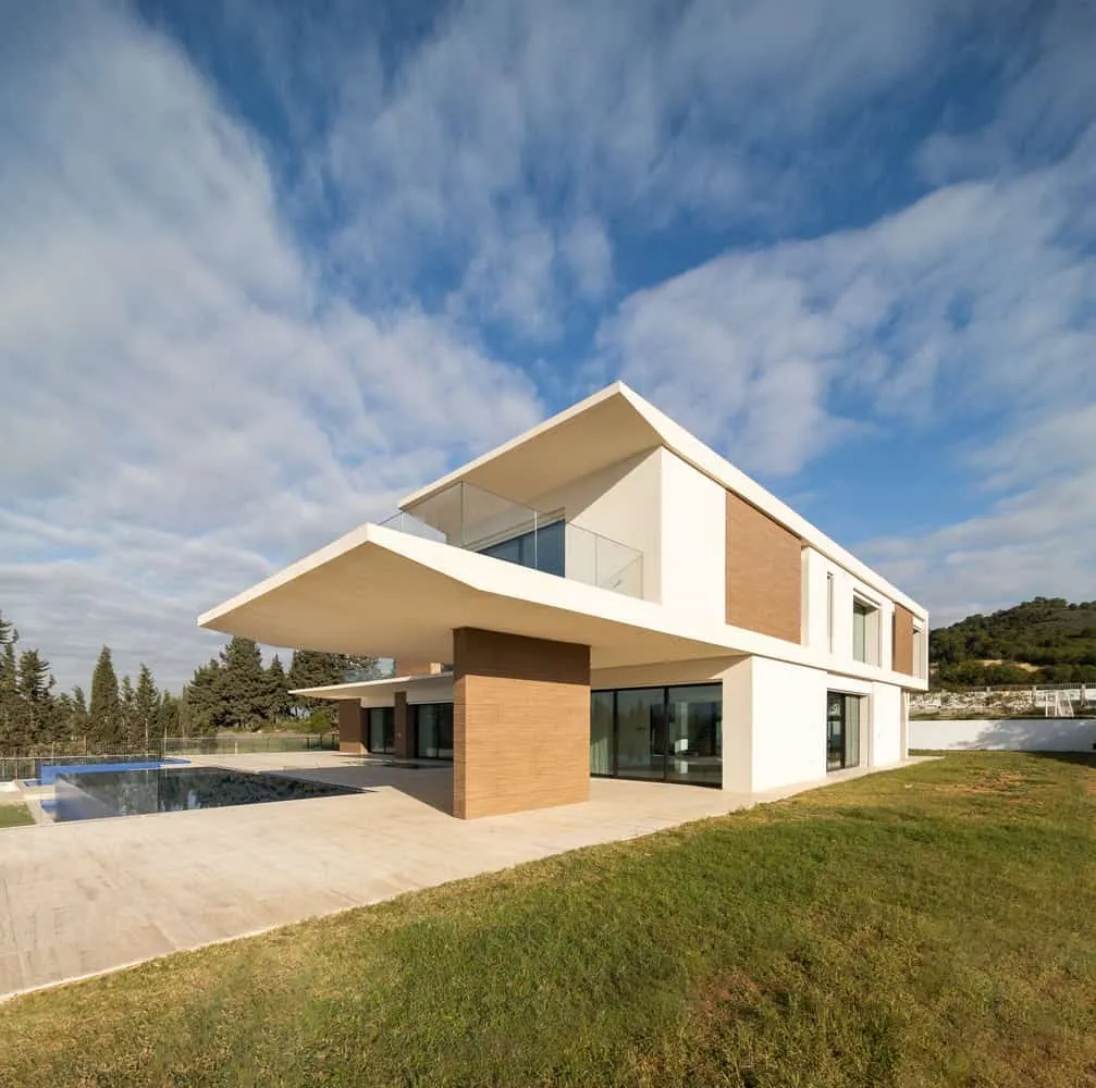 Calm view of Villa Air's pool at night, reflecting the illuminated facade