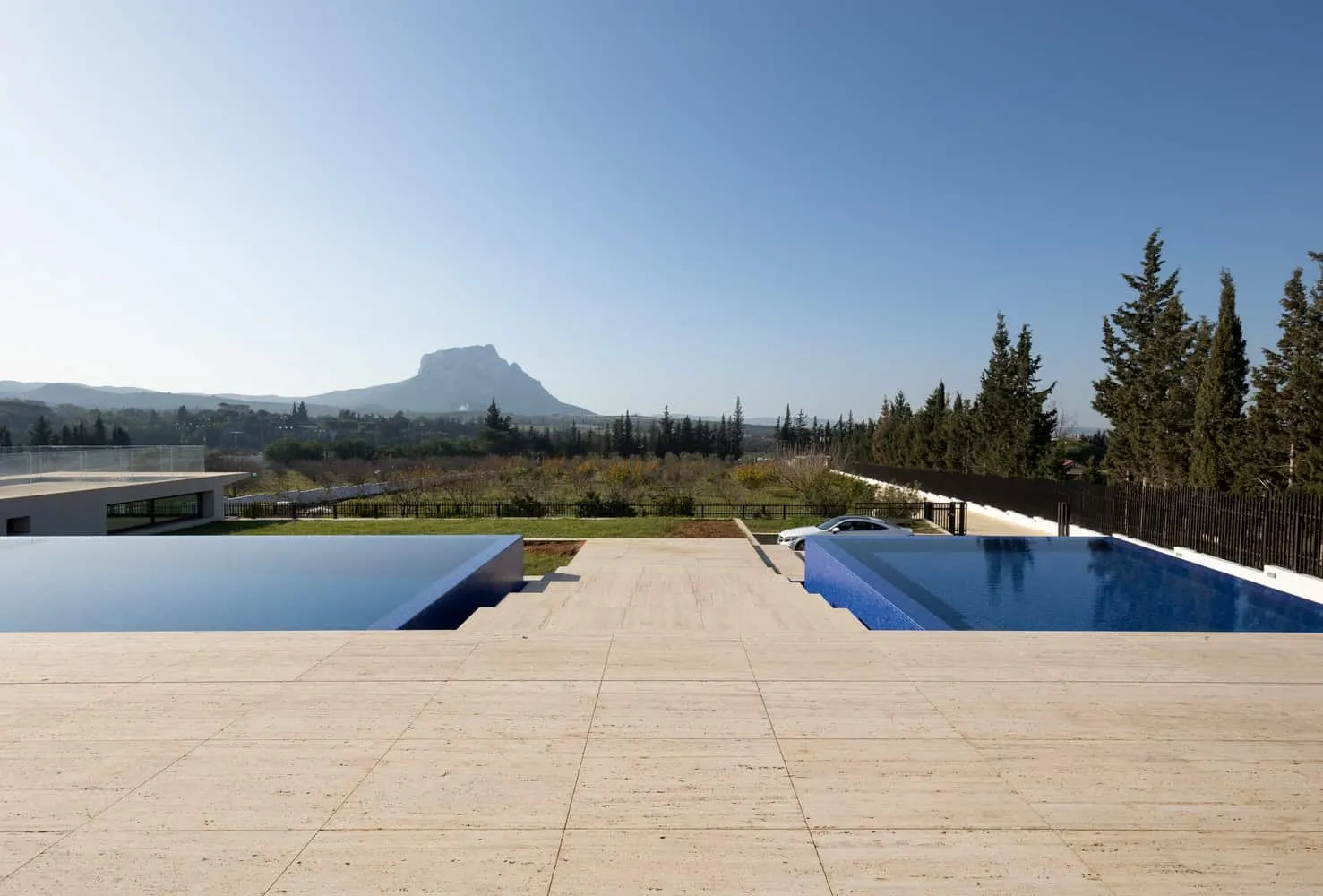 Infinity pool and steps with tall trees in the background