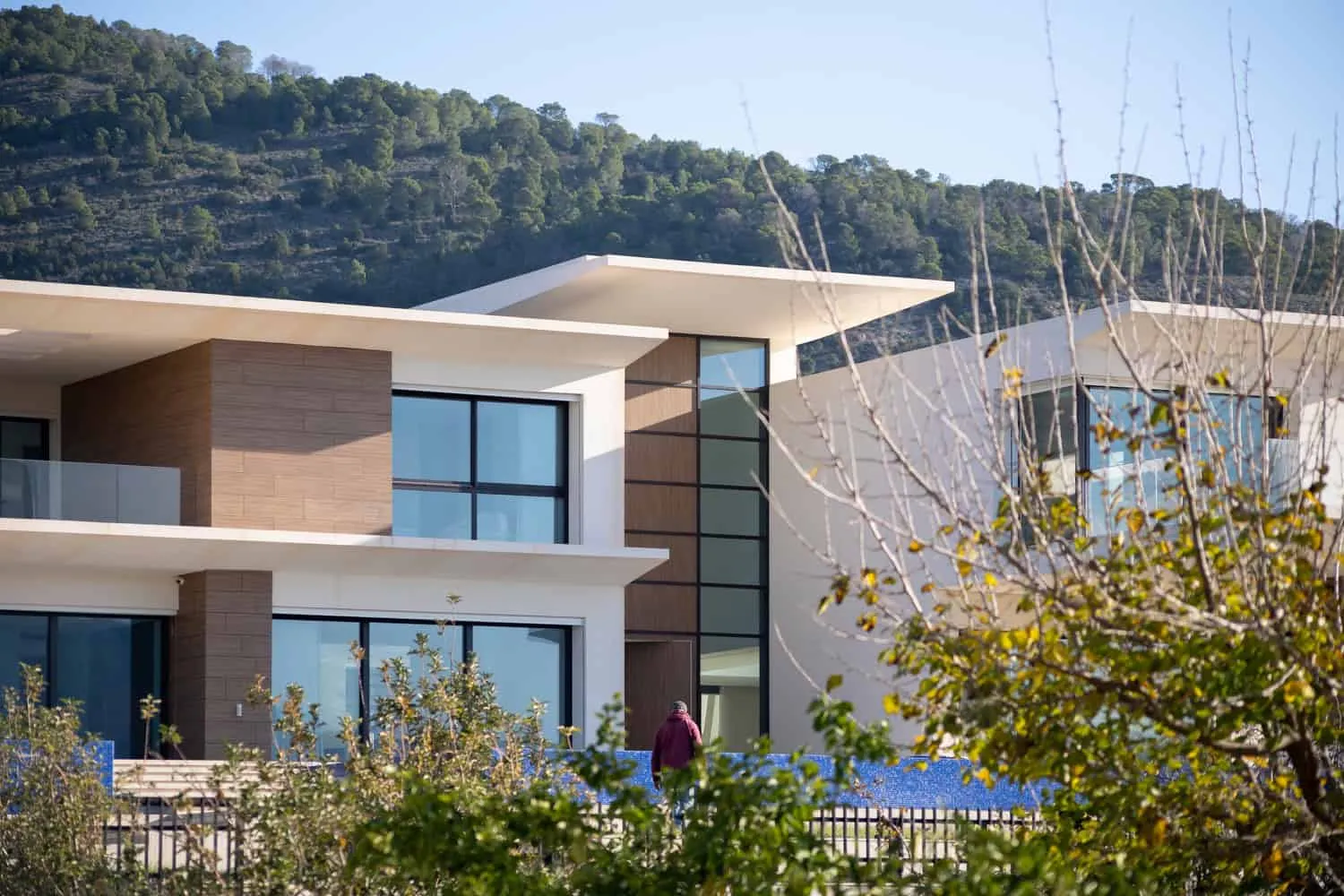 Close-up view of the wooden facade of Villa Air and glass balcony