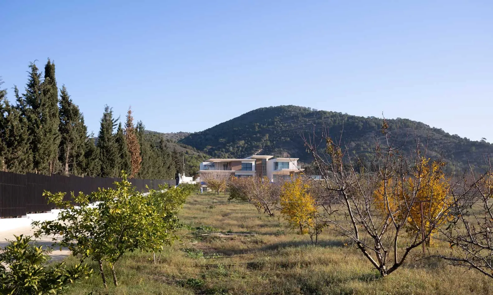 Distant view of Villa Air among the slopes of the landscape