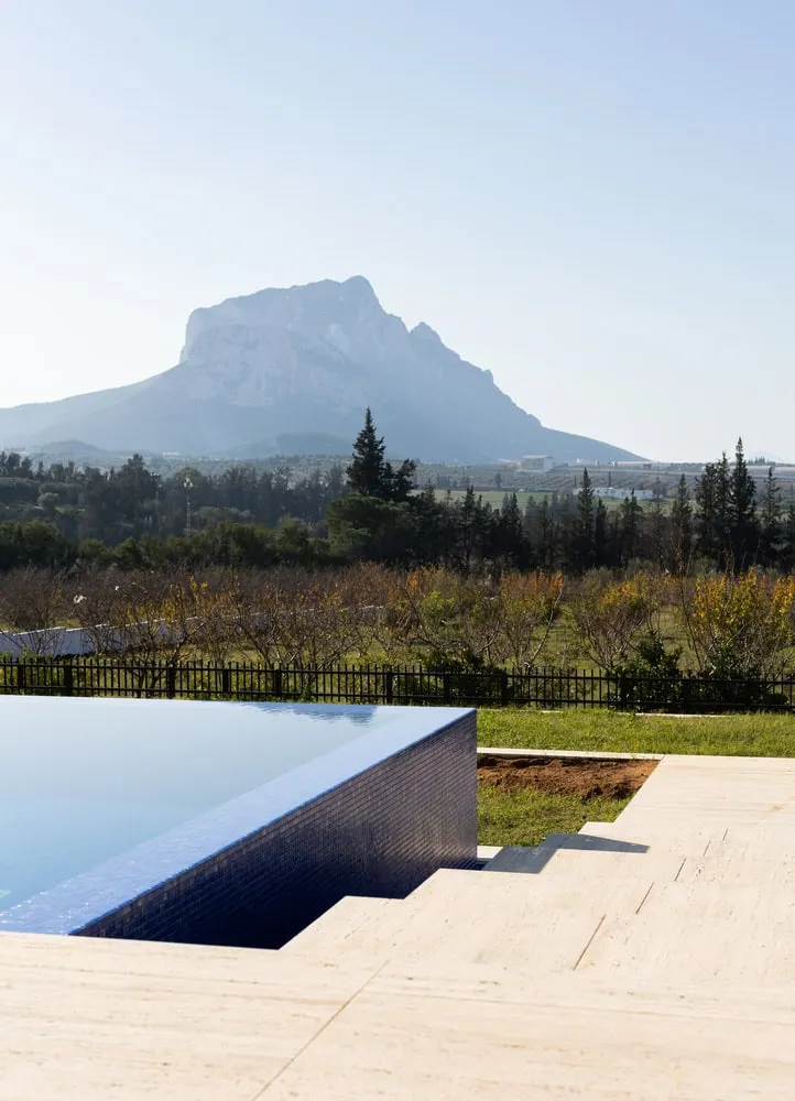 Symmetrical double infinity pool oriented towards distant Tunisian mountains