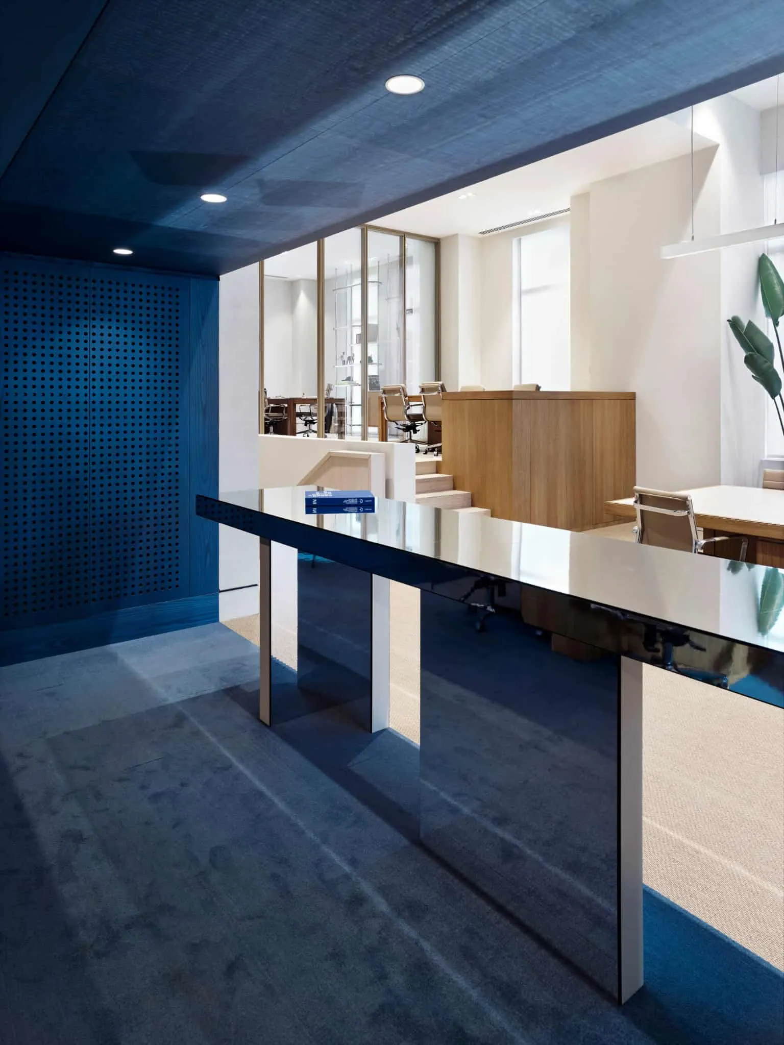 Staggered office zoning with light wood finish and height variations by URBANJOBS