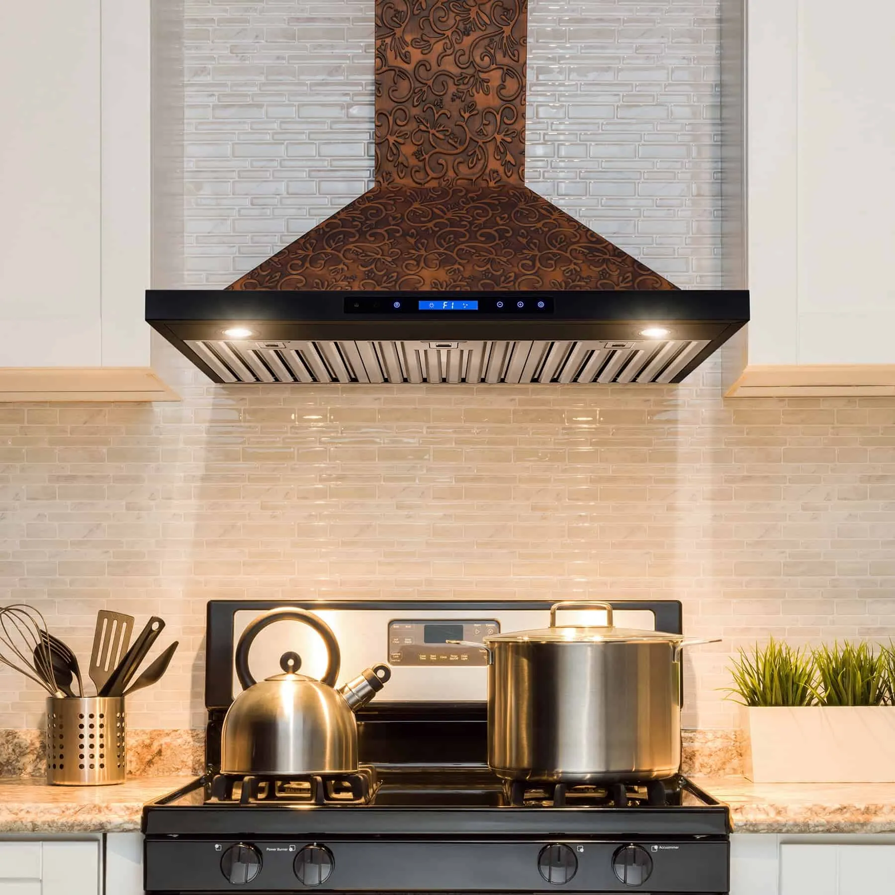stainless steel wall-mount range hood in modern kitchen