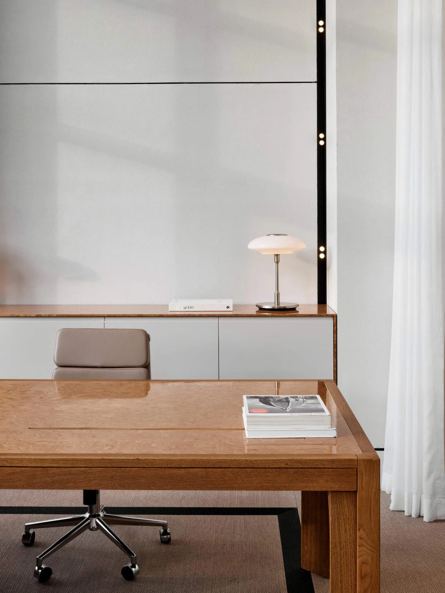 Chrome shelf and rounded wooden cabinet in Özlenir Headquarter