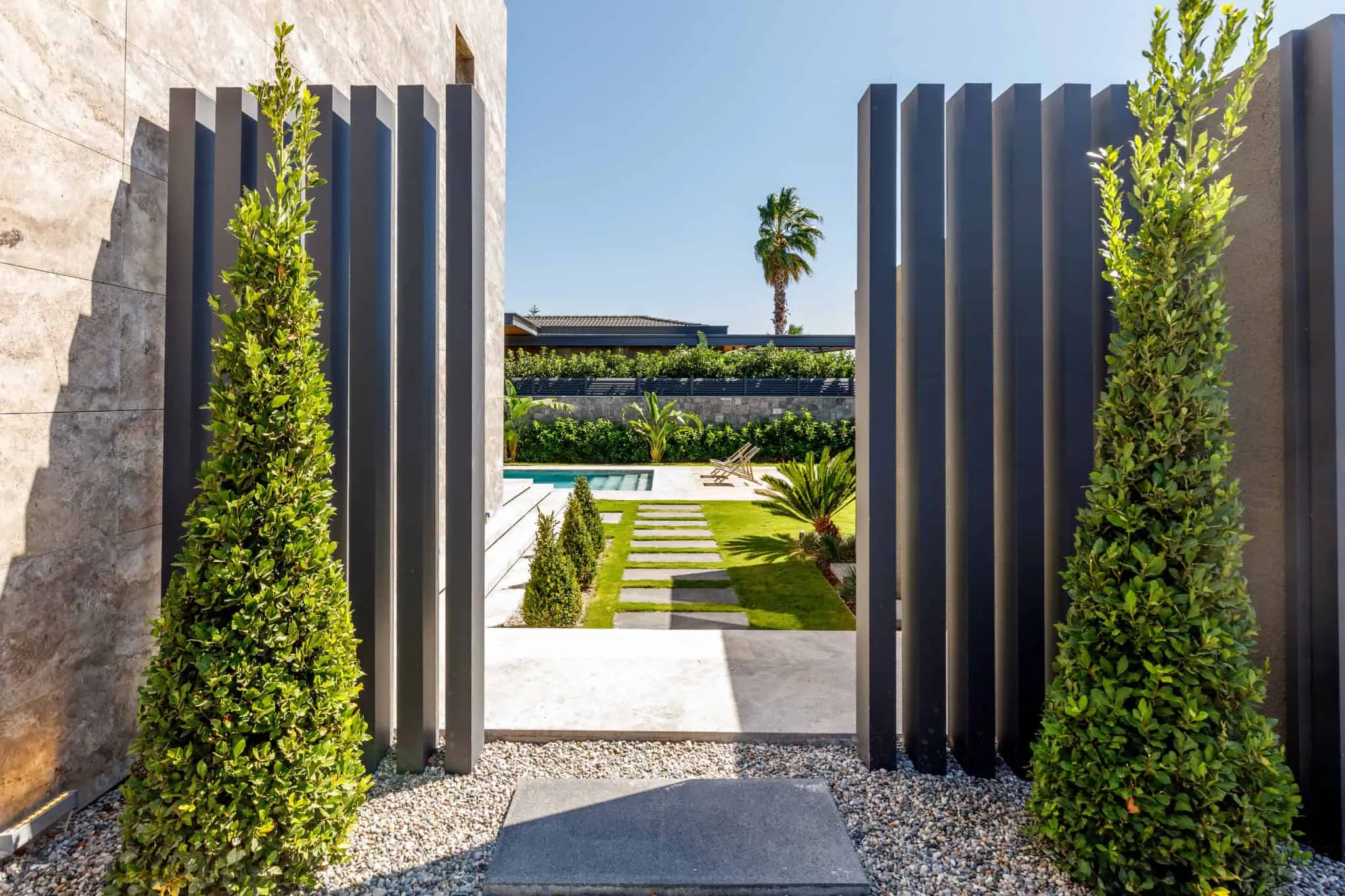 Casa Pendenza view through garden gate toward pool by BAD – Başak Akkoyunlu Design, Mamurbaba, Çeşme, İzmir