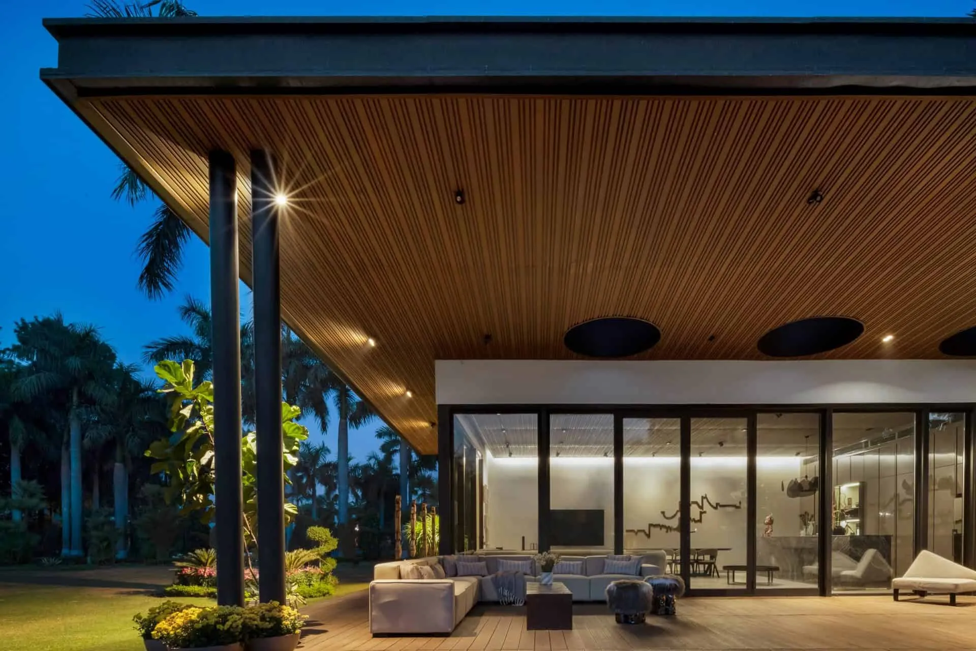 Terrace lounge area at sunset in UrbanMistrii's Pool House in Chatarpur, Delhi.