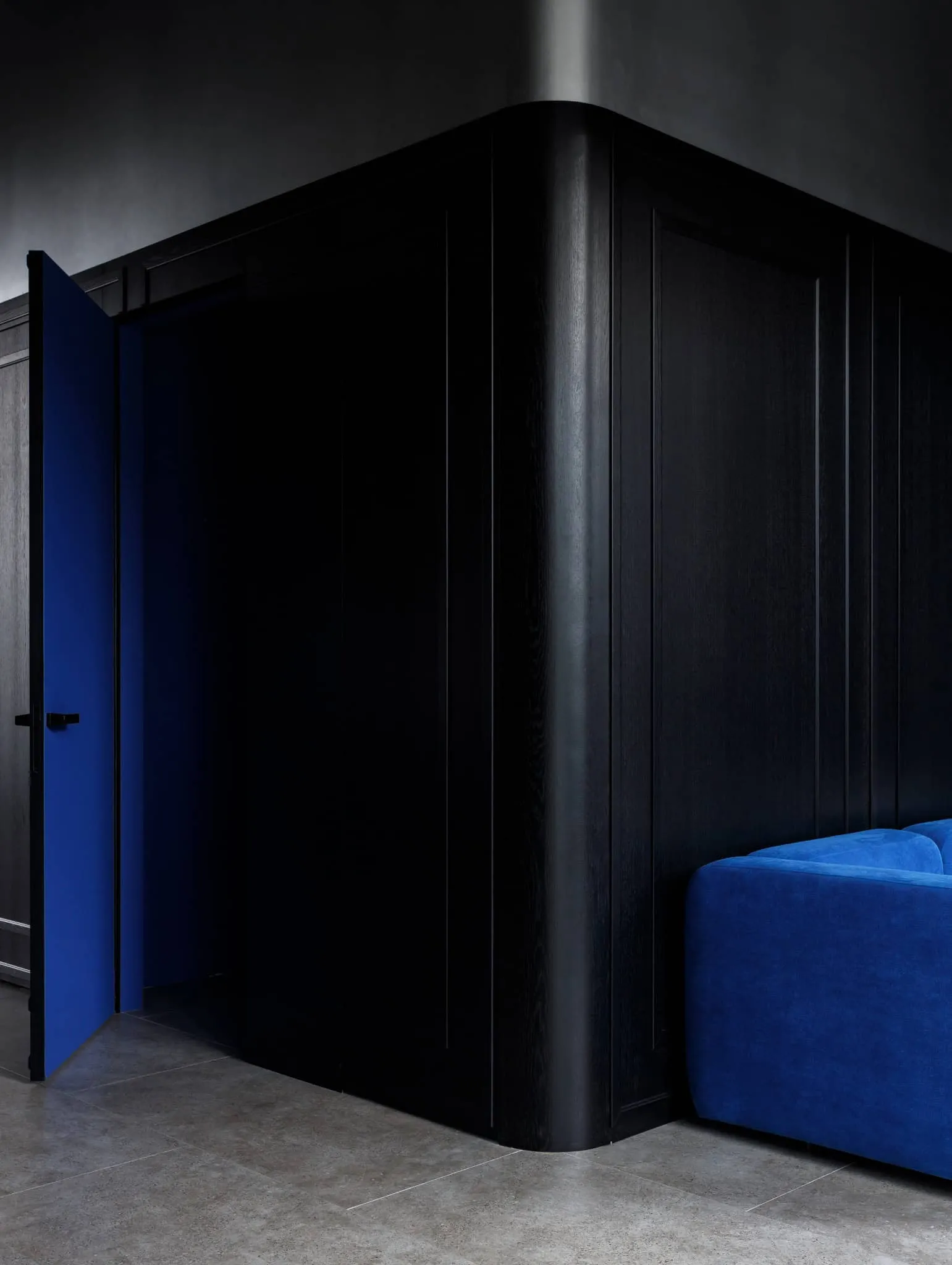 Modern minimalist interior by Julia Starikova – open blue door and black wall in Chelyabinsk, Russia