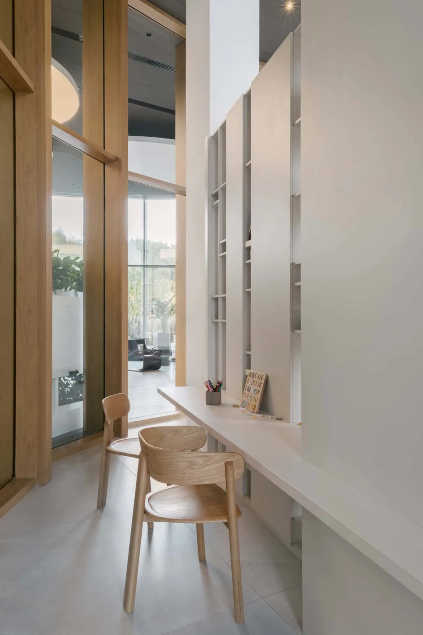 Minimalist office interior with natural wood and white accents, elegant shelf and large windows for bright open workspace – perfectly suited to modern architecture and interior design.