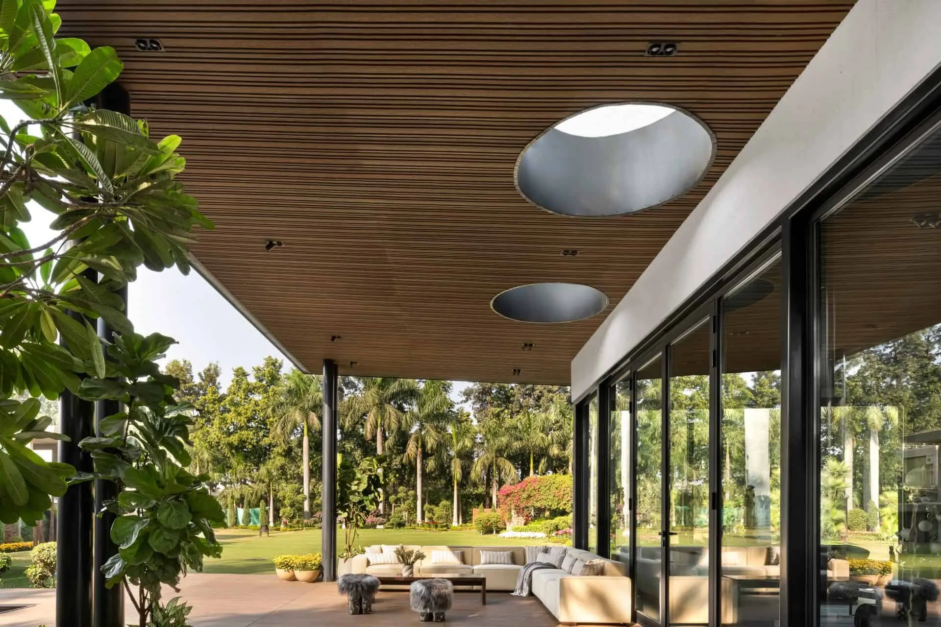 Outdoor relaxation area in UrbanMistrii's Pool House in Chatarpur, Delhi.