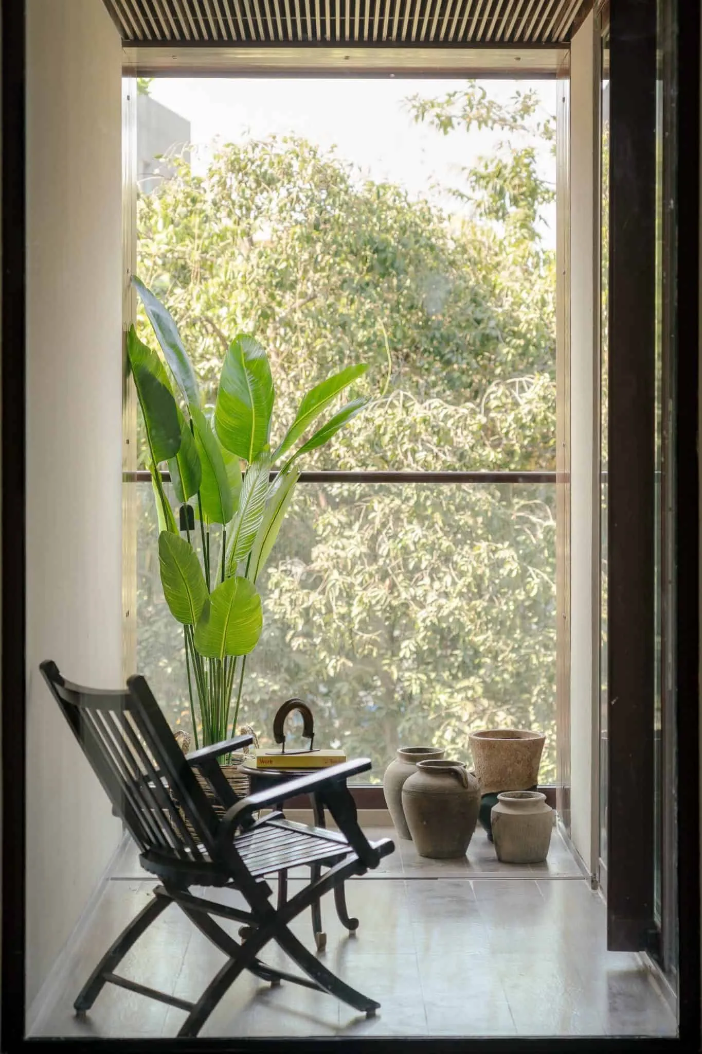 House Of Lines Boat Club – Reading Nook on Balcony with Green Plants, Chennai