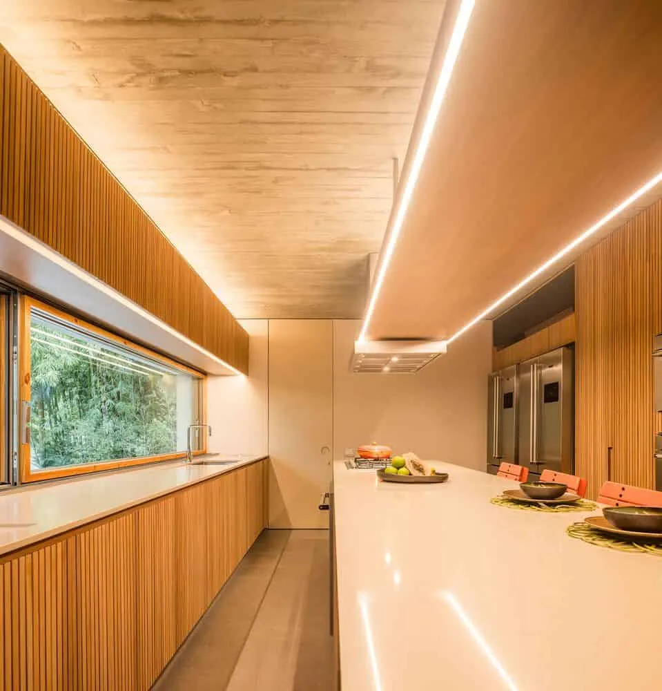 Canopy House by Studio MK27 – kitchen with linear wood joinery, Guarujá, Brazil