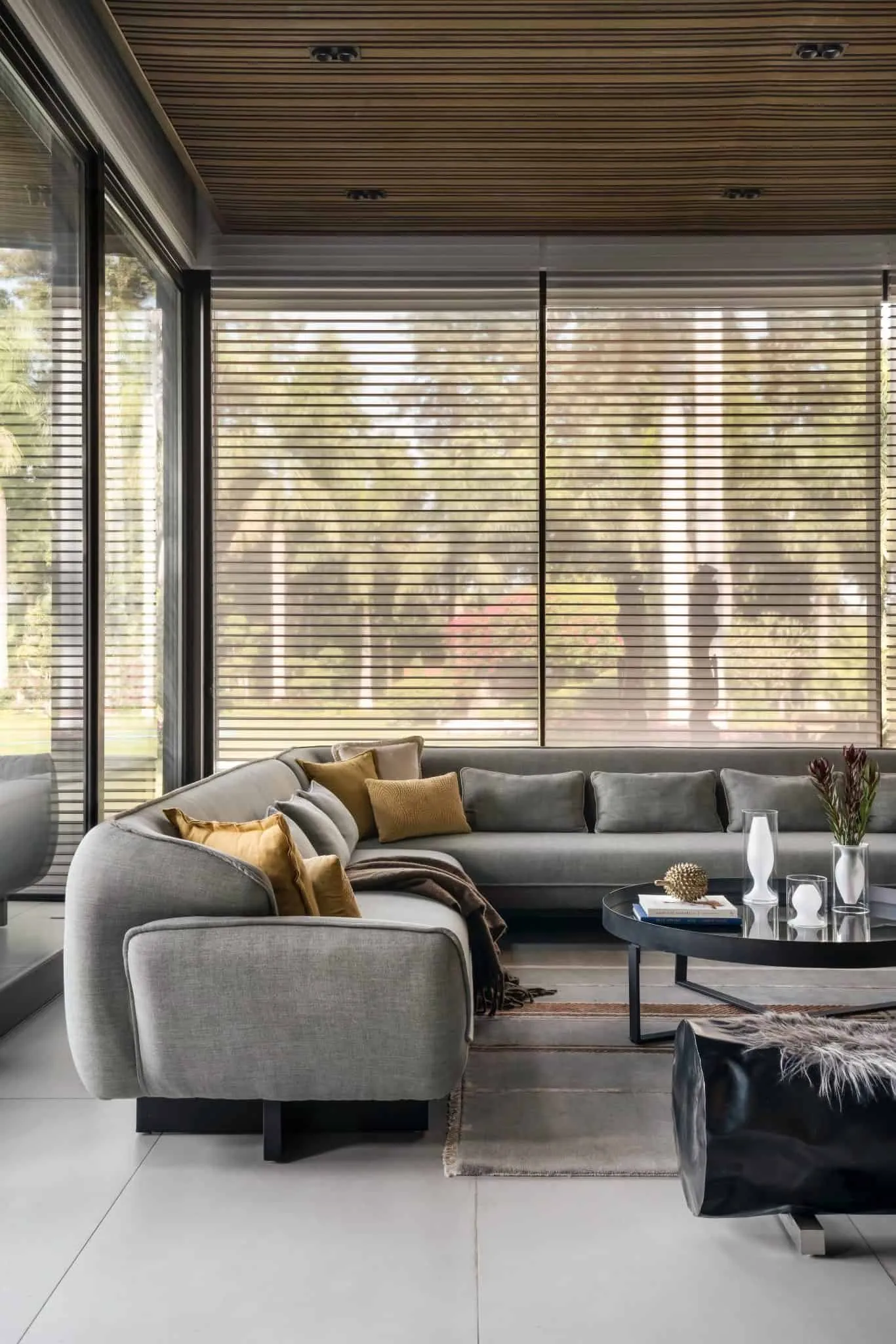 Sofa corner with full glazing in UrbanMistrii's Pool House – Chatarpur, Delhi