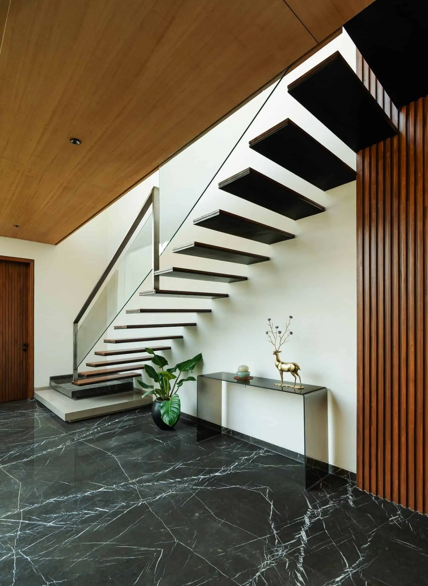 Minimalist House by Crest Architects — staircase with overhang and glass railing, Bangalore, India
