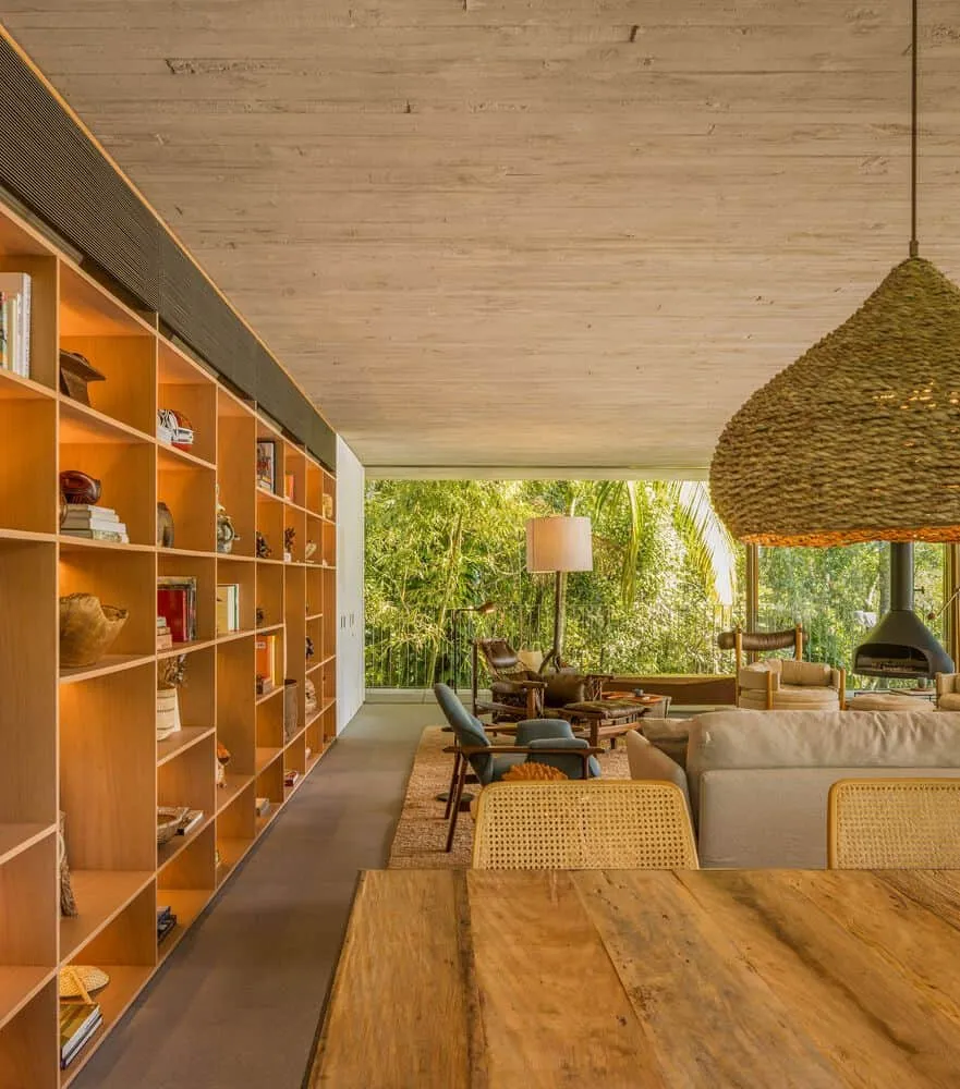 Canopy House by Studio MK27 – living room with large bookshelf, Guarujá, Brazil