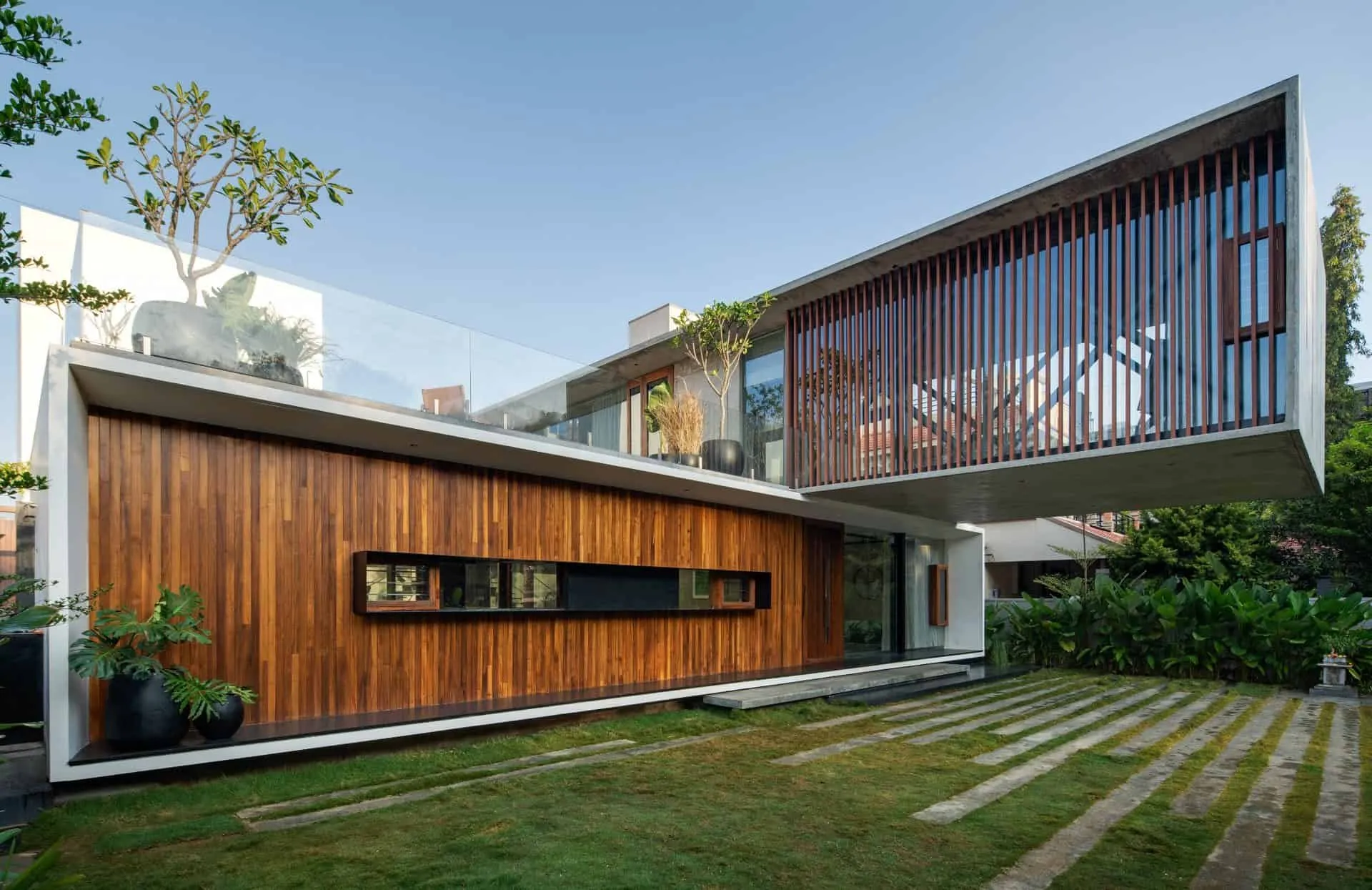 Minimalist House by Crest Architects — side view with wooden louvers, Bangalore, India
