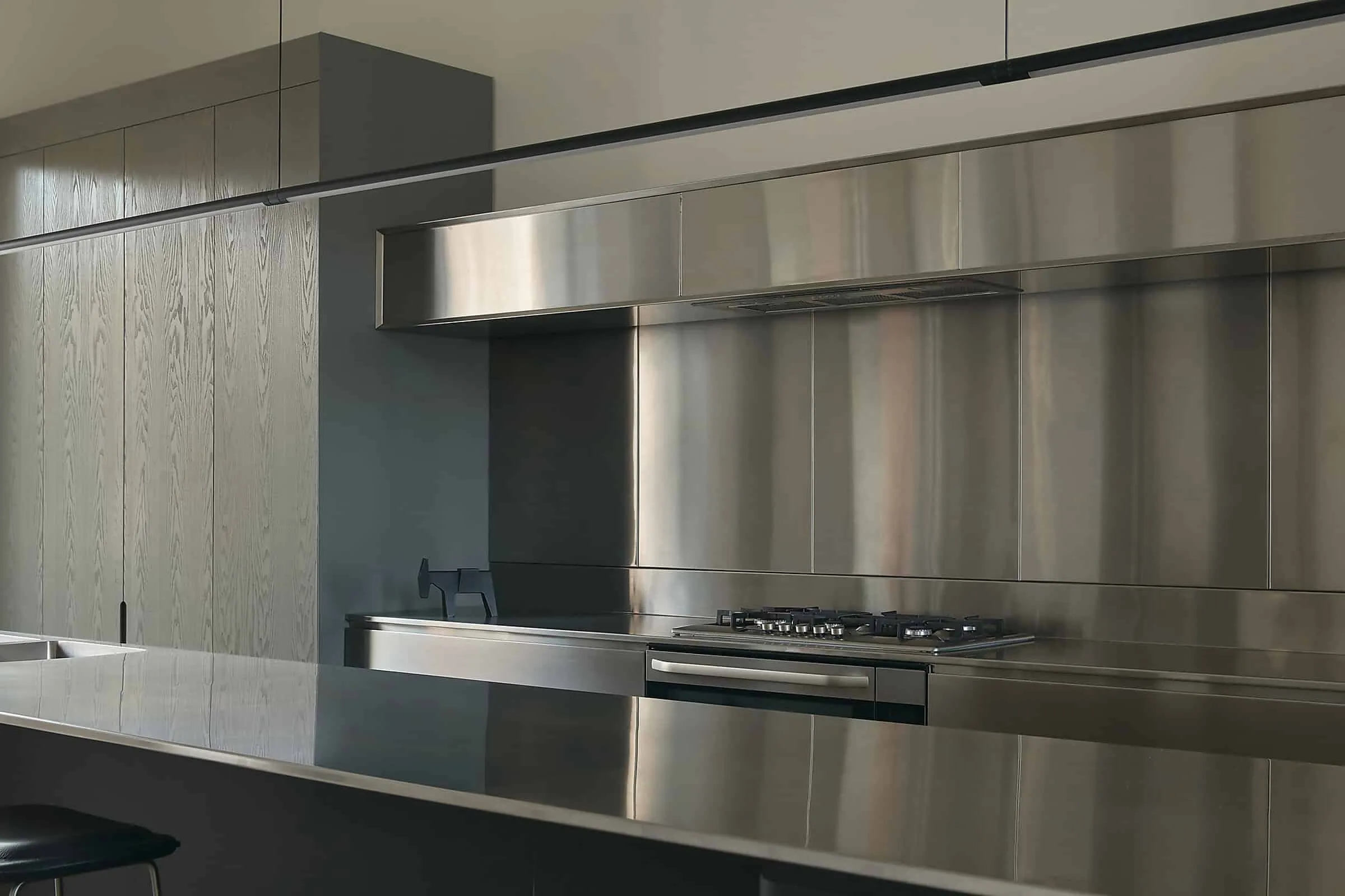 Modern stylish kitchen with steel appliances, minimalist cabinet furniture and elements of modern design for a stylish home interior.