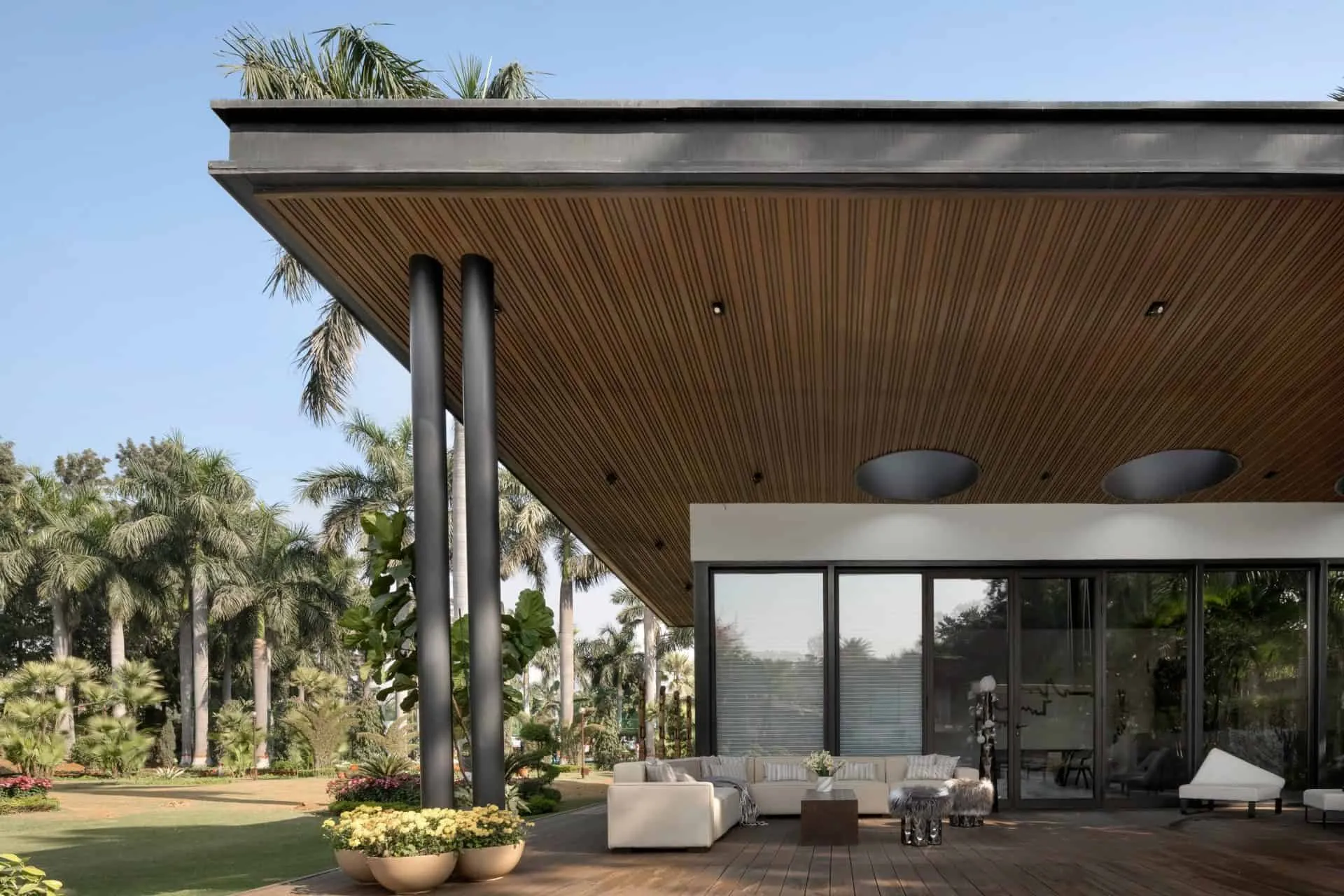 Terrace lounge area in UrbanMistrii's Pool House in Chatarpur, Delhi.