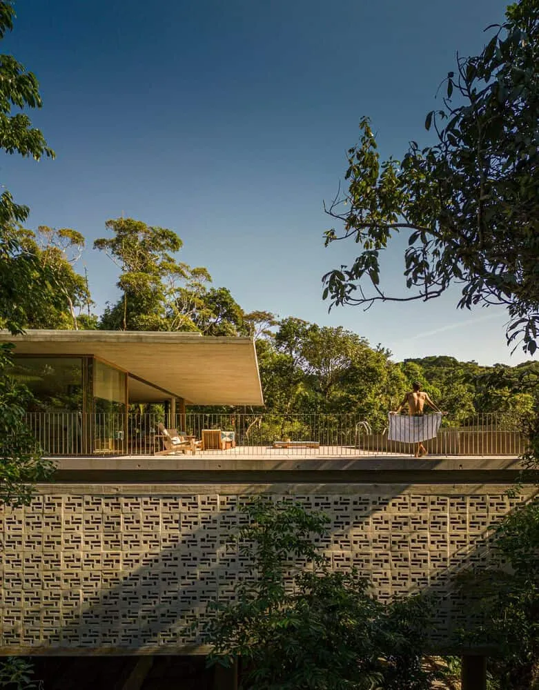 Terrace view of Canopy House by Studio MK27 with a man overlooking the forest, Guarujá, Brazil