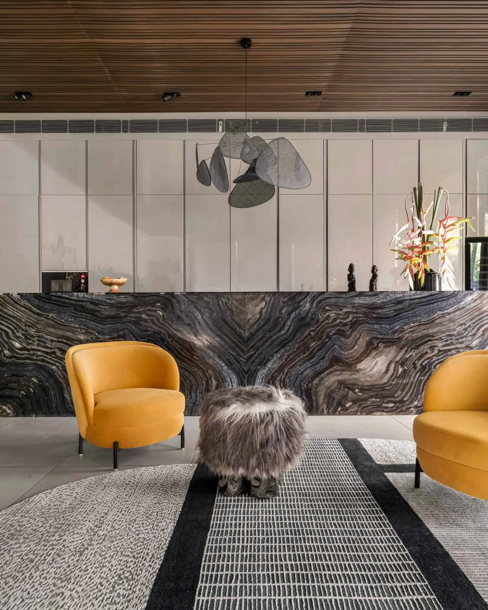 Seating arrangement in front of the bar area in UrbanMistrii's Pool House – Chatarpur, Delhi