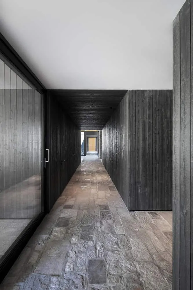 Hallway with wooden finishes inside the La Baie de l'Ours house
