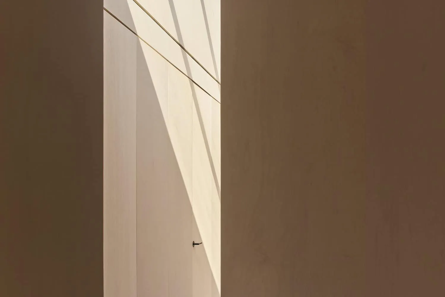 Elegant Modern Interior with Minimalist Wood Cladding and Soft Natural Light, Highlighting Geometric Design Elements