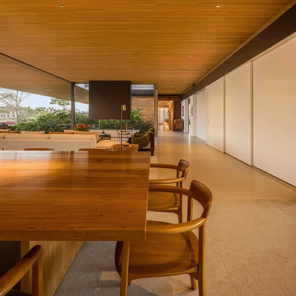 House TM by Jacobsen Arquitetura – long view through dining and corridor, Brazil