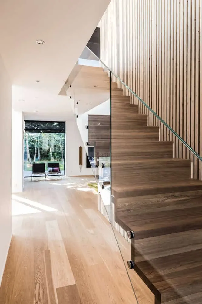 Villa S — evening view with warm interior light and expressive facade