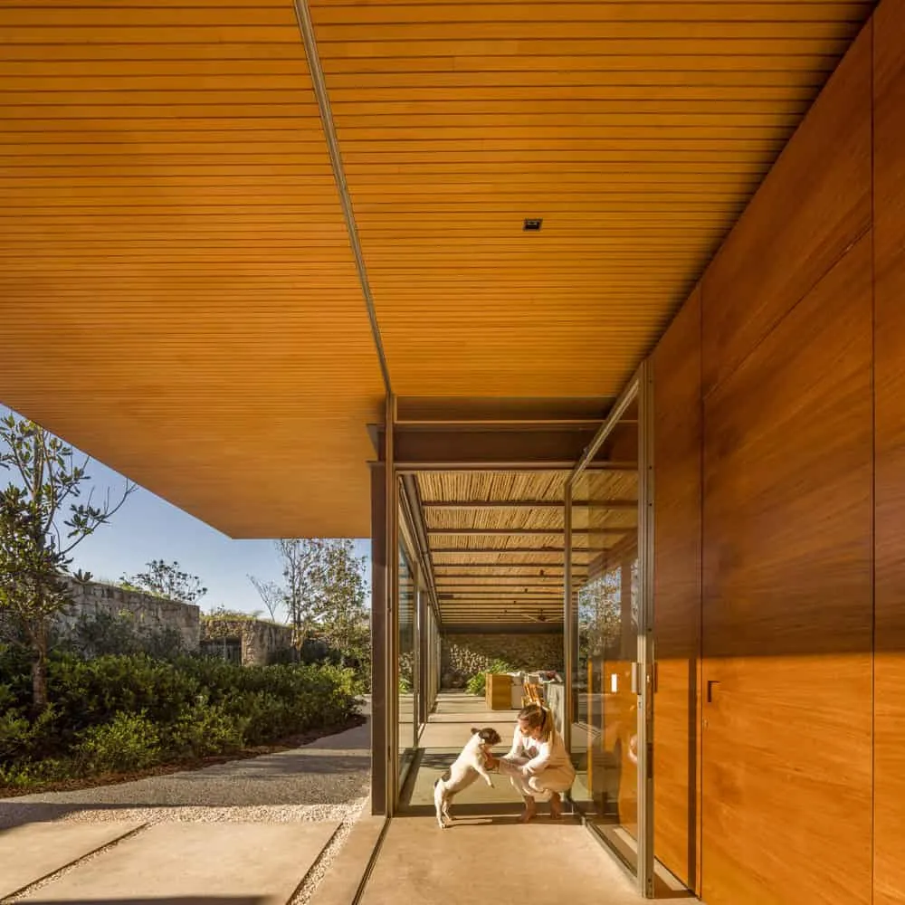 House TM by Jacobsen Arquitetura – glass terrace with interaction of interior and exterior, Brazil