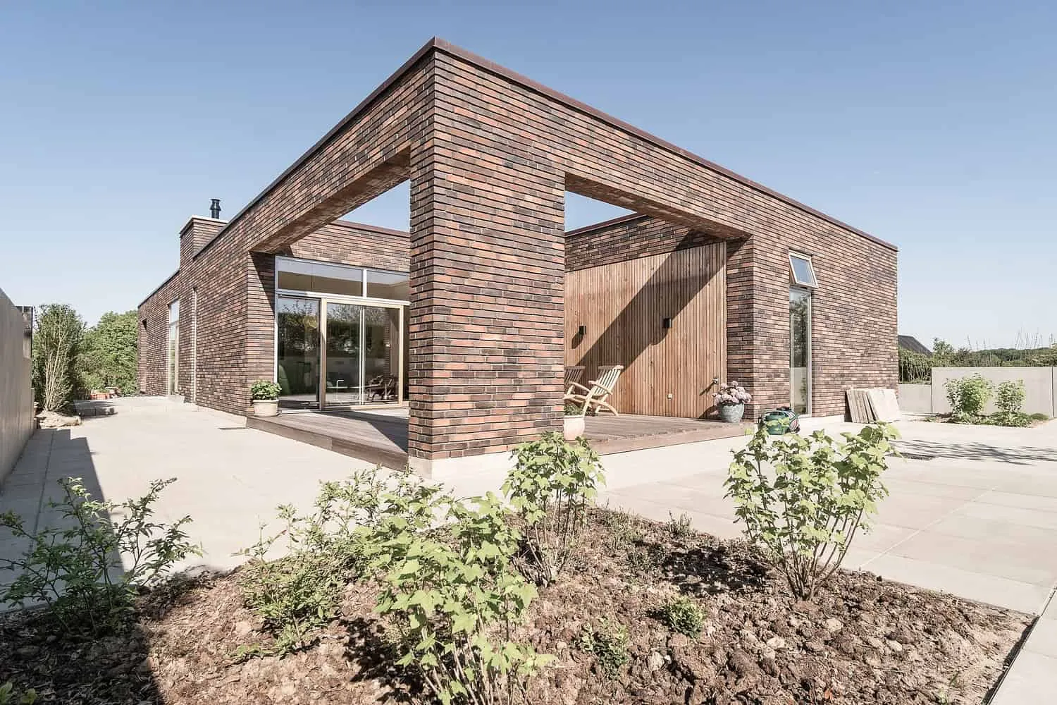 Carved terrace voids connecting interior spaces with the landscape