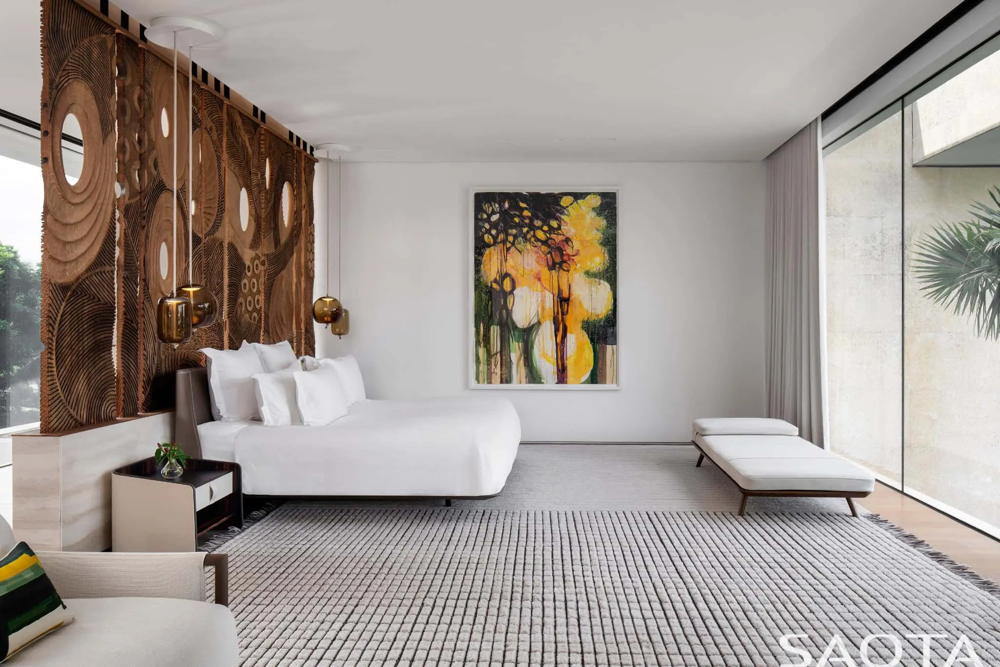 Master bedroom with artistic panel and seamless garden view