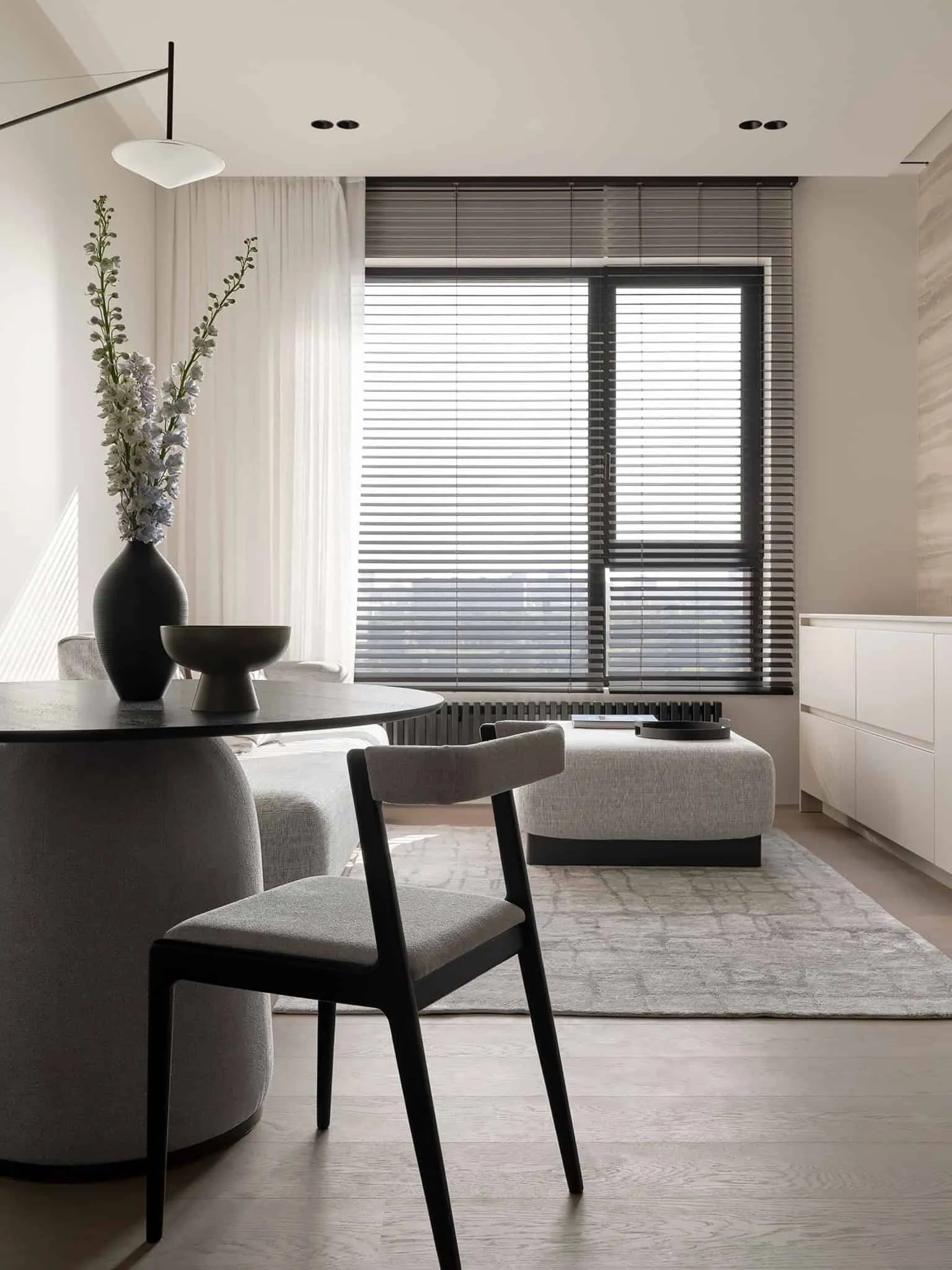 View from dining area to living room with large blinds - warm minimalism from Alexander Tishler's design studio, Moscow