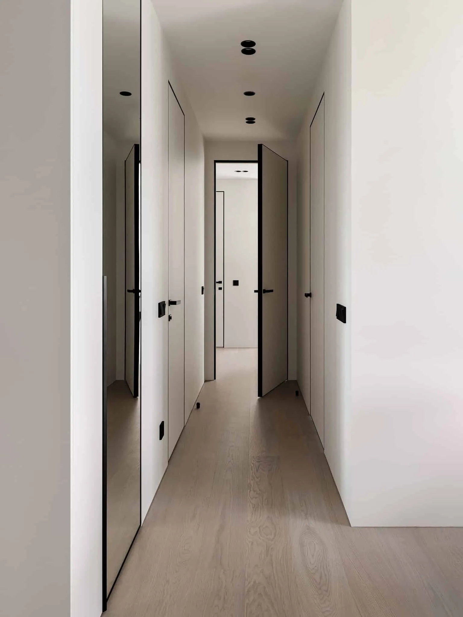 Long minimalist hallway with inset doors - apartment with warm minimalism from Alexander Tishler's design studio, Moscow