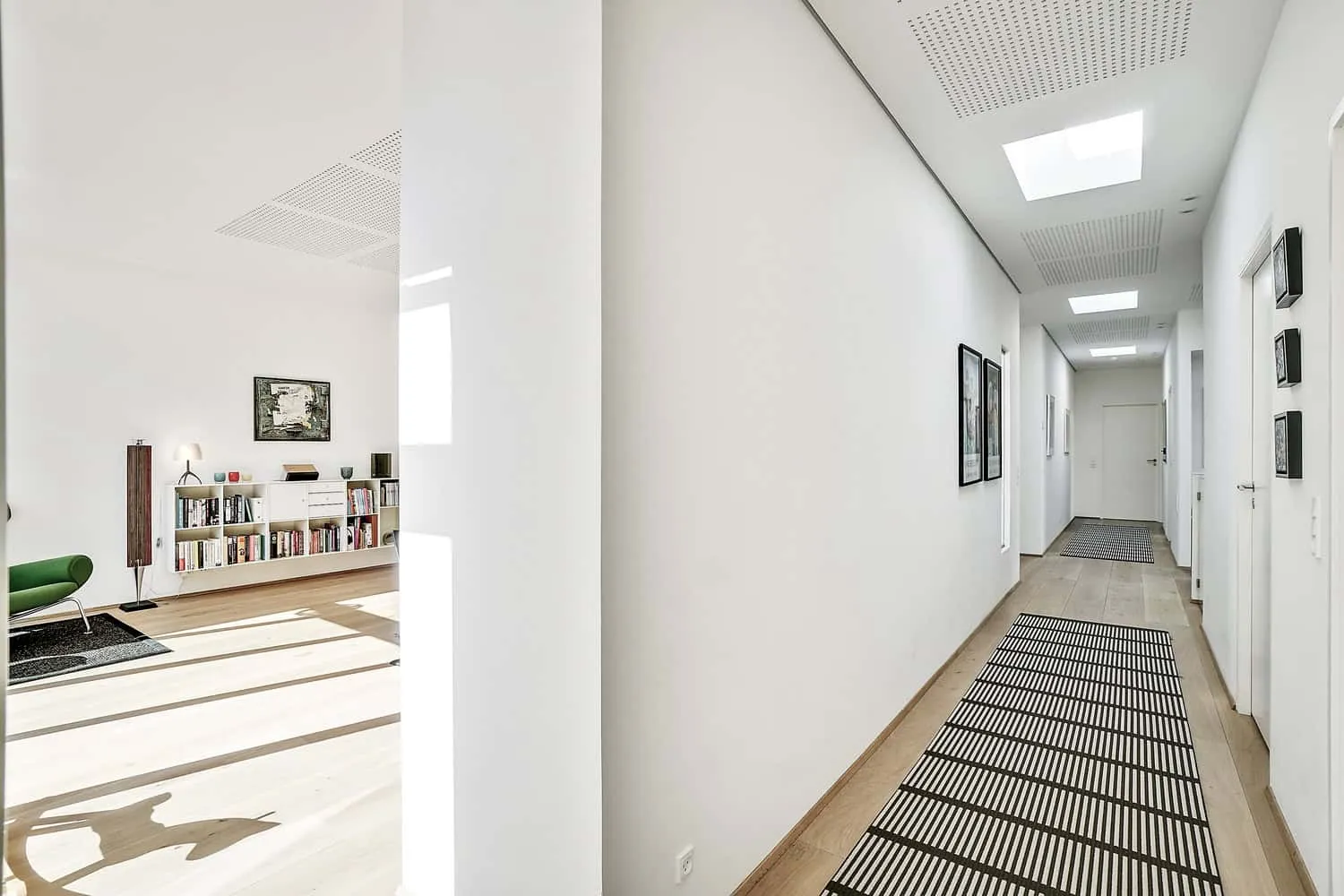 Evening view highlighting carved volumes and warm interior light