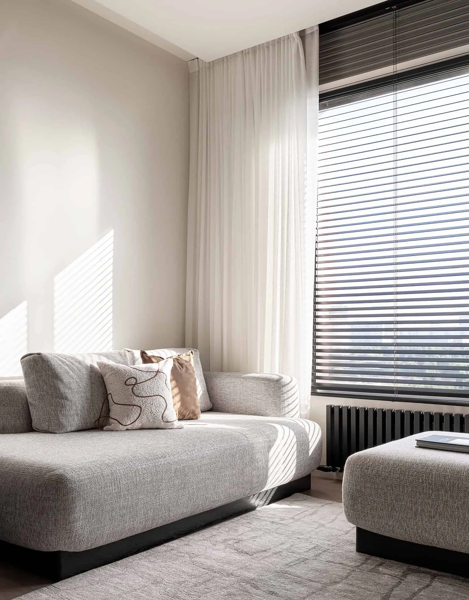 Close-up of sofa in apartment with warm minimalism from Alexander Tishler's design studio in Moscow, Russia