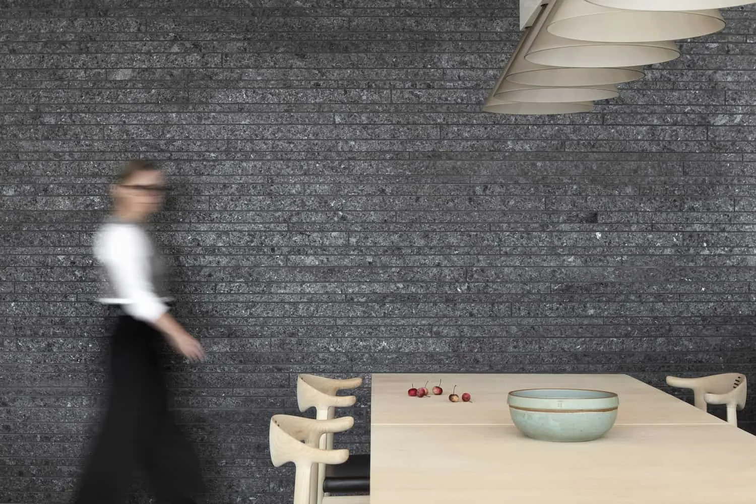 Dining Area Detail with Textured Stone Wall of Sagamore North Cottage by Akb Architects