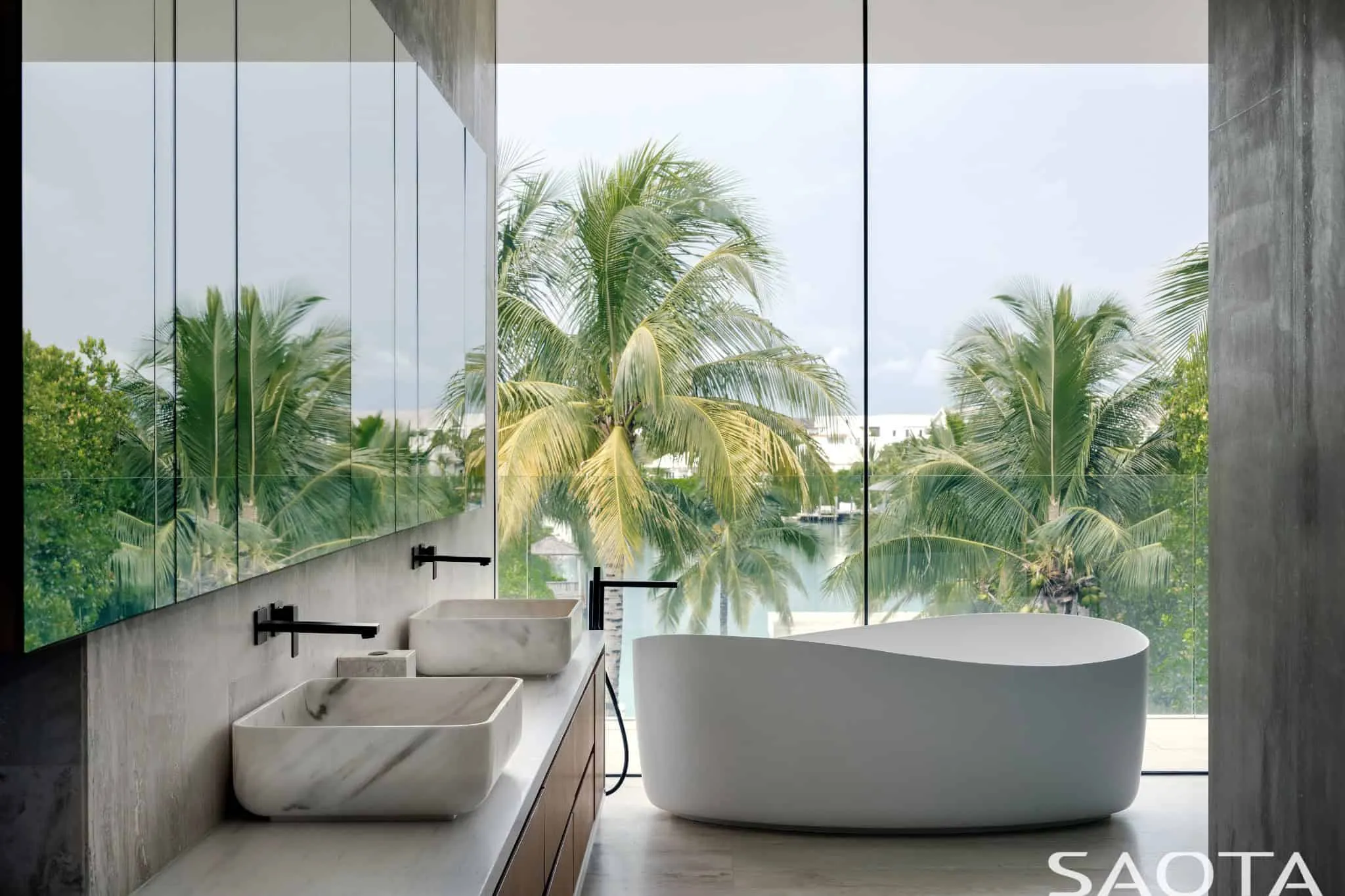 Bathroom with vanity and view of palms and lagoon