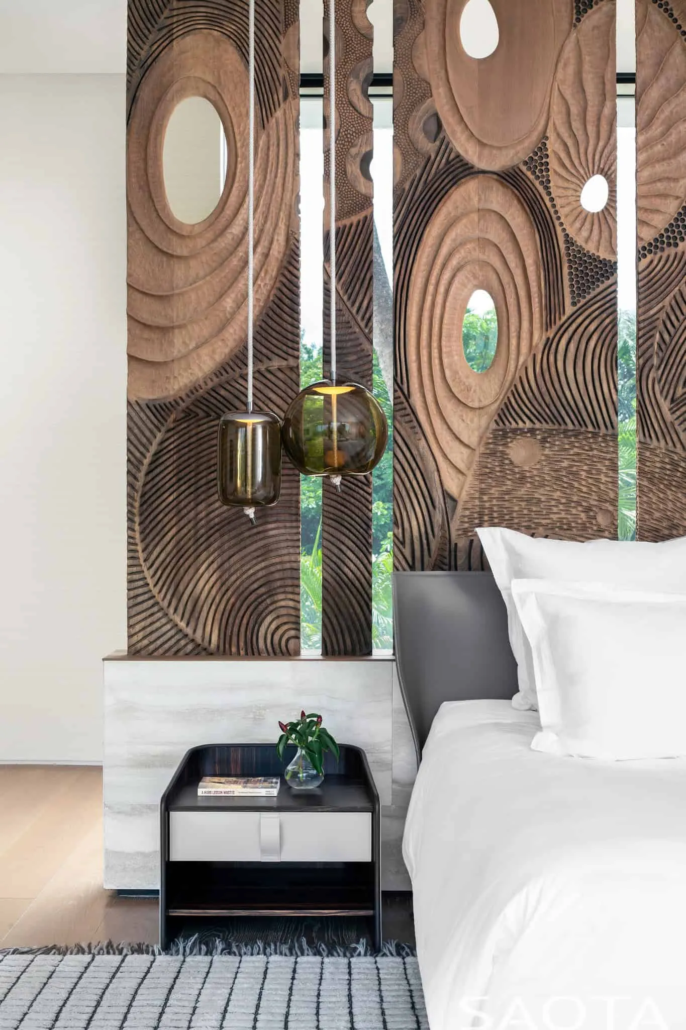 Bedroom detail with carved wooden panel and lights