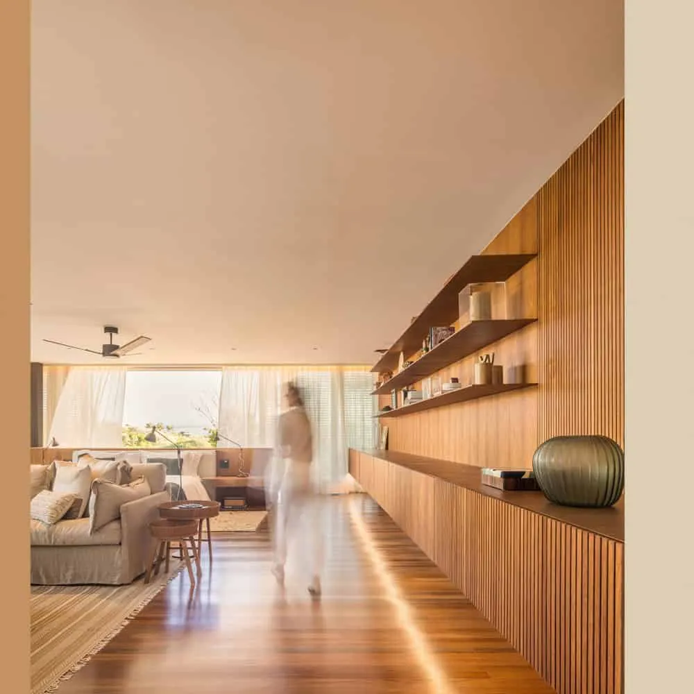 House TM by Jacobsen Arquitetura – warm wooden living room with shelves, Brazil