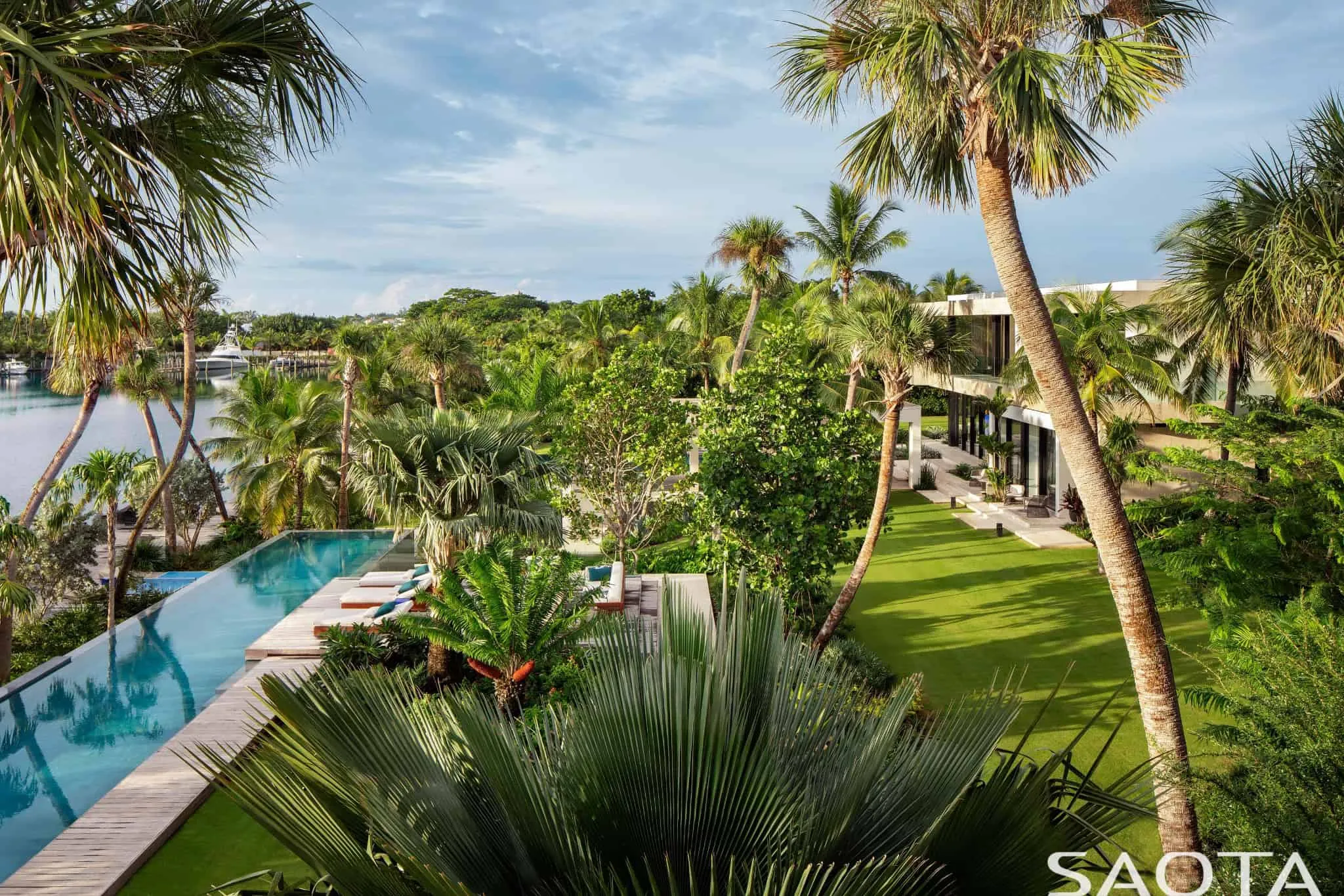Aerial view of gardens and pool by lagoon