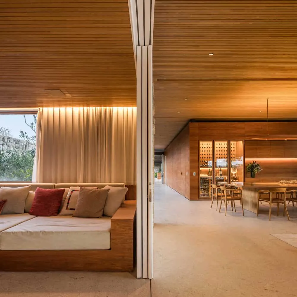 House TM by Jacobsen Arquitetura – sliding door between living room and dining, Brazil