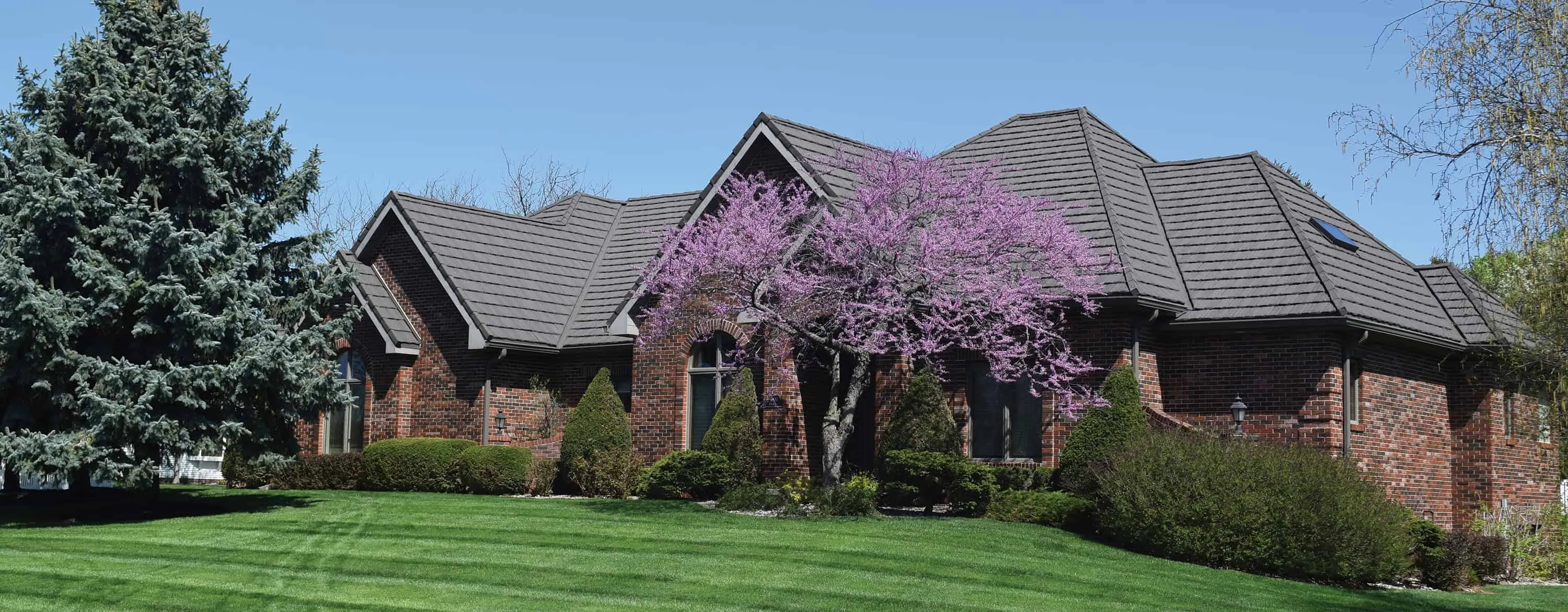 Modern home with composite synthetic roofing – lightweight, durable roofing imitating slate and cedar textures