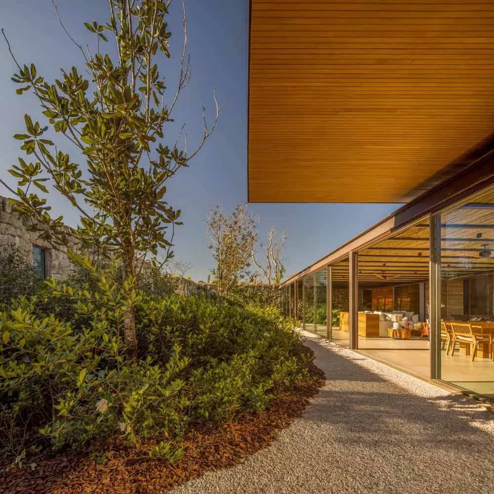 House TM by Jacobsen Arquitetura – garden path along glass terrace, Brazil