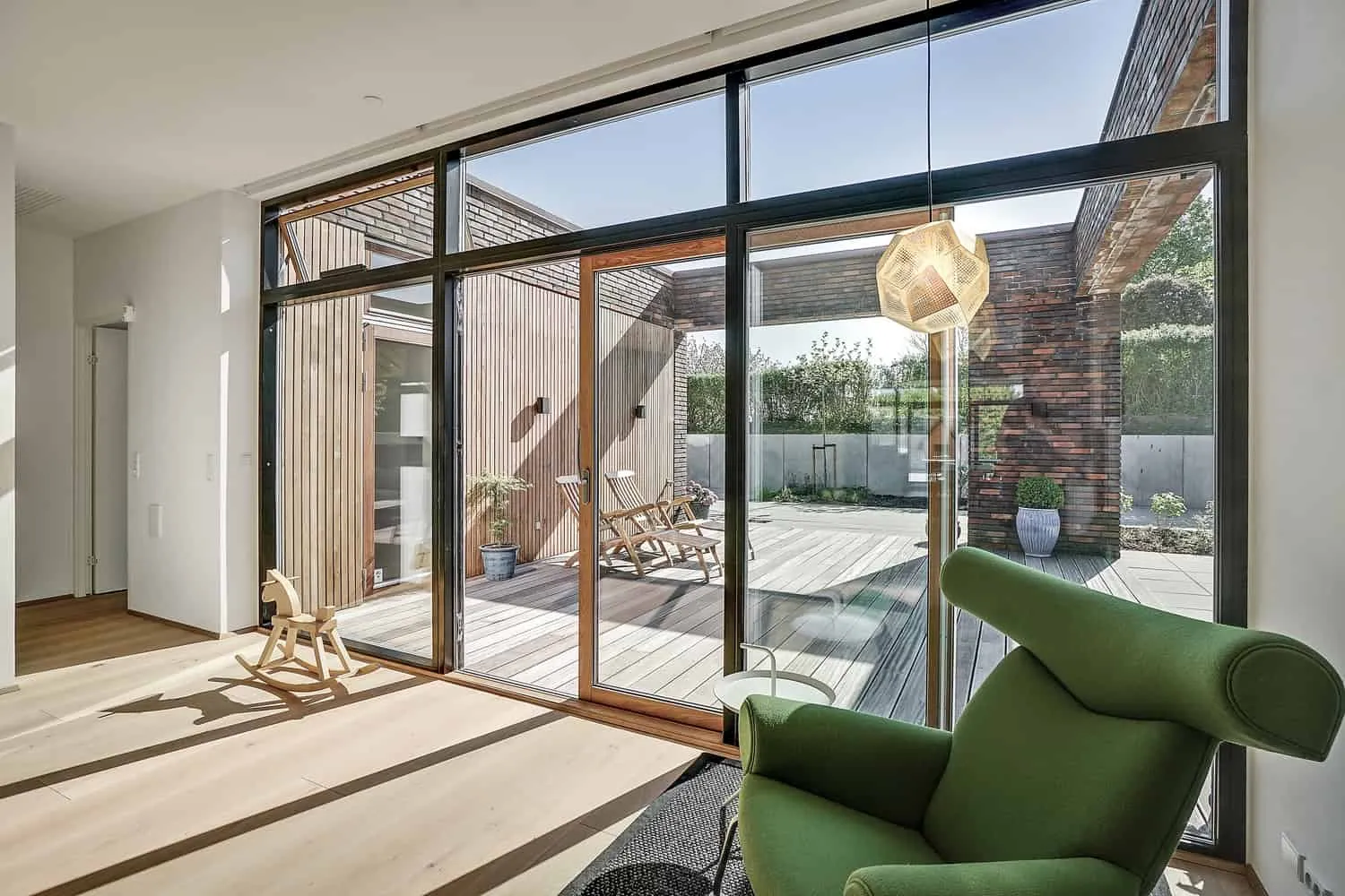 Meeting of brick wall, concrete slab, and cedar cladding