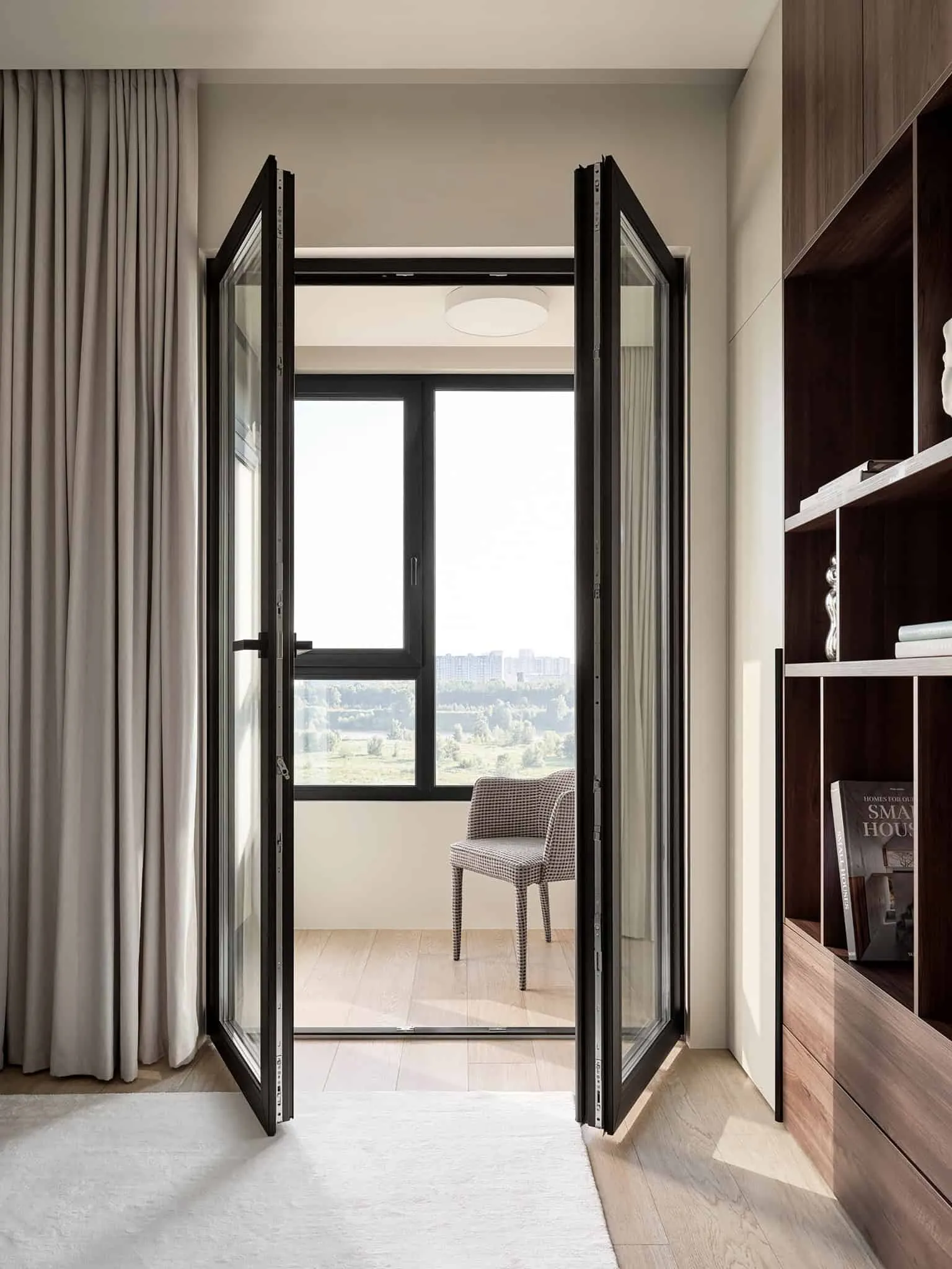 Balcony with folding doors and chair - apartment with warm minimalism from Alexander Tishler's design studio, Moscow