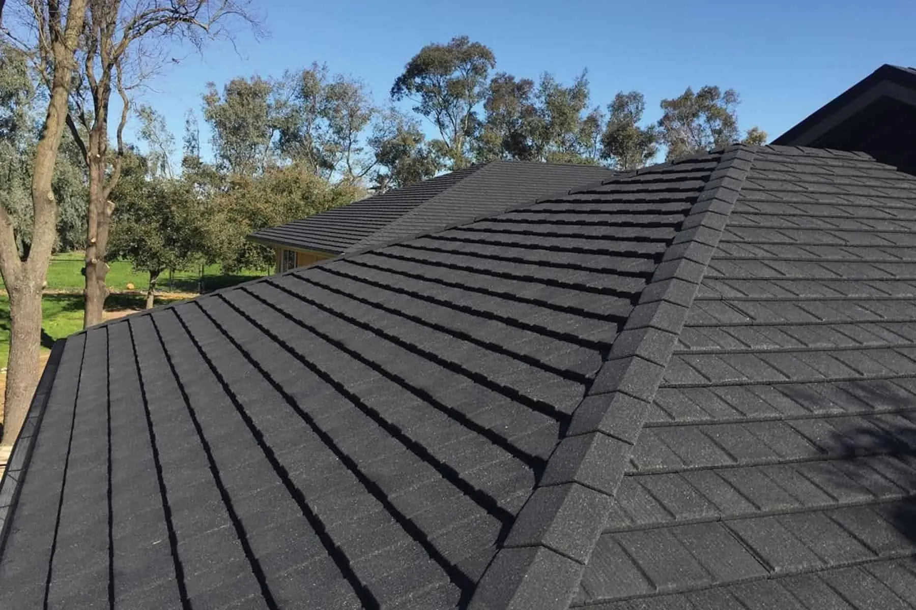 Modern home with stone-coated steel roofing – textured, durable metal roofing for high wind regions