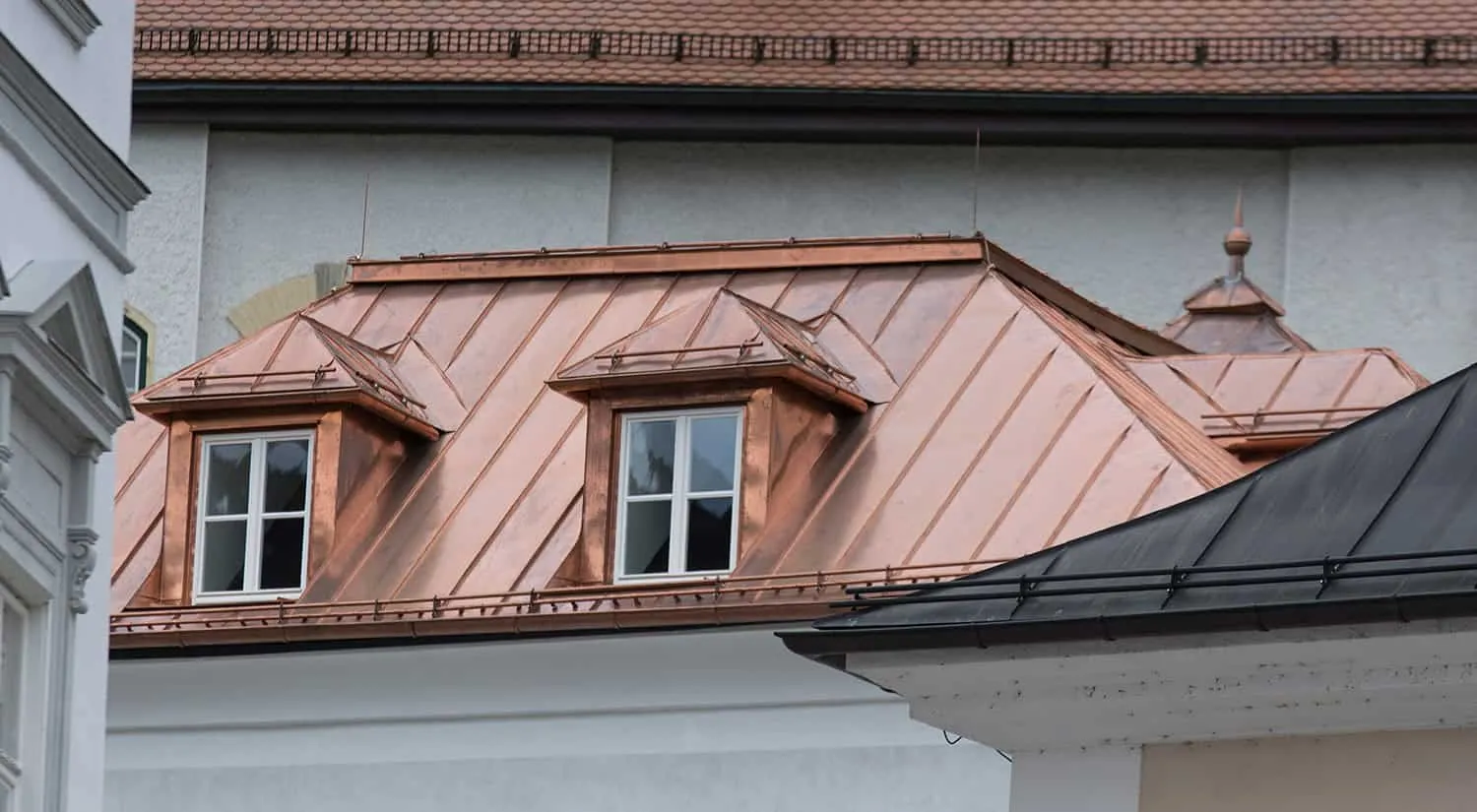 Architectural building with copper roofing – premium metal roofing developing natural green patina over time
