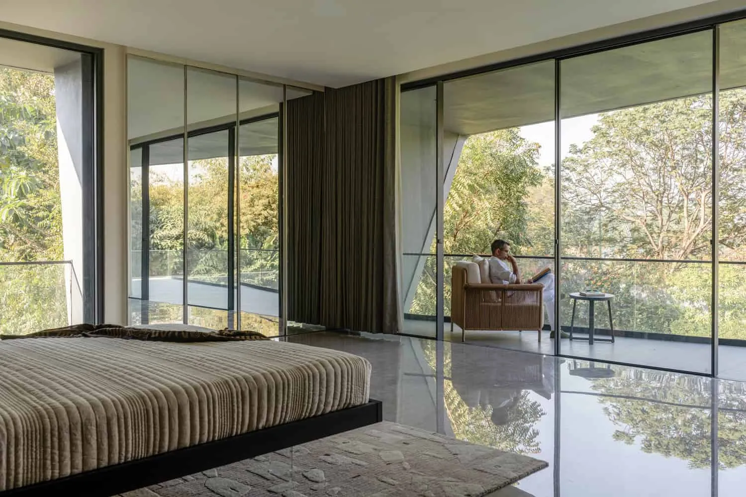 Bedroom with corner glazing and framing terrace in House NINE X NINE in Gandhinagar