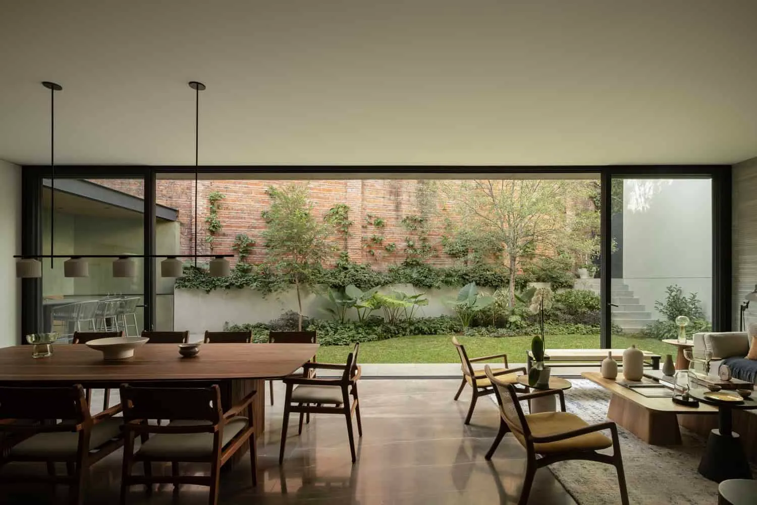 Casa DLCA Interior Hallway by 0studio Arquitectura Casa DLCA by 0studio Arquitectura interior hallway with wooden doors in Zapopan Mexico