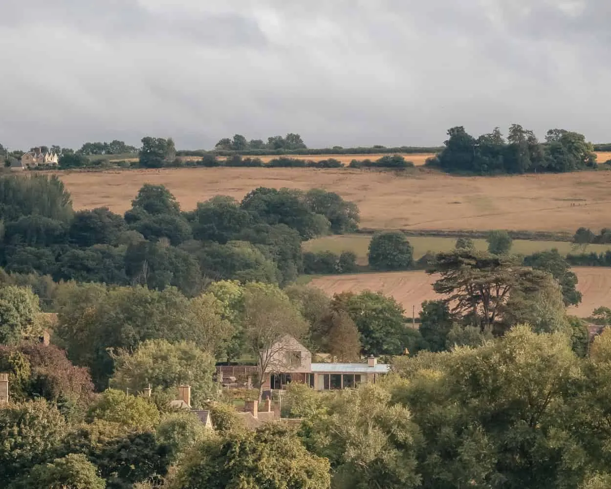 Cotswolds में स्थित Oliver Leech Architects द्वारा डिज़ाइन किया गया Cotswolds House, घाटी के प्राकृतिक दृश्यों के बीच